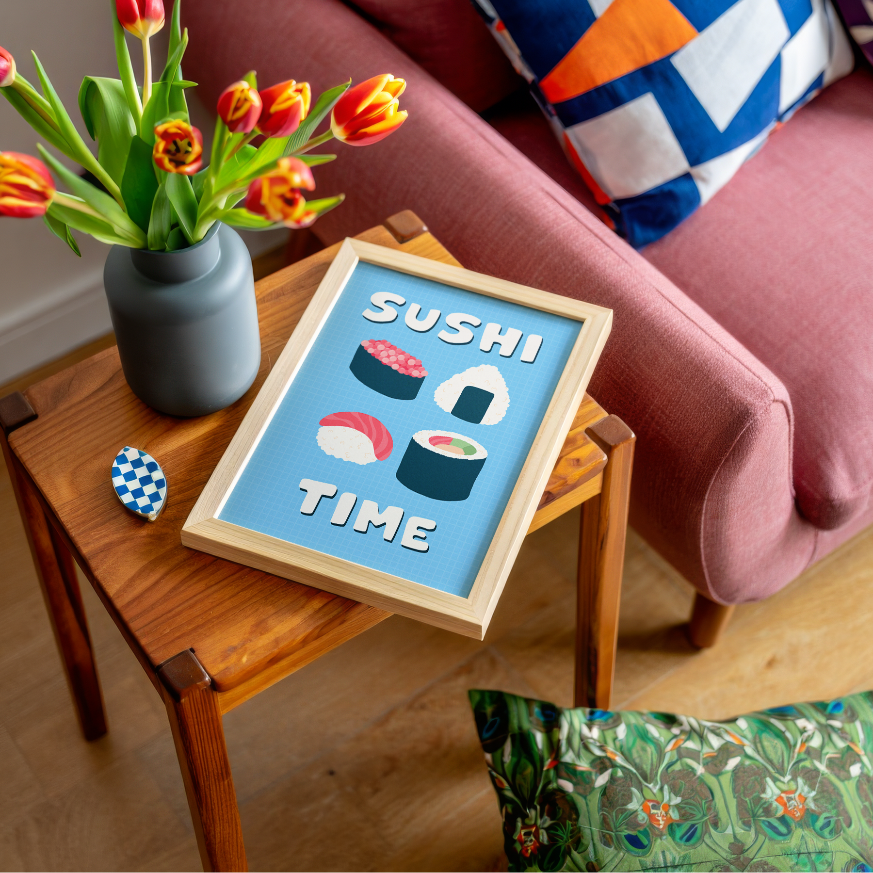 A blue wall art print, with illustrations of sushi in the centre. Around the sushi illustration, are the words 'Sushi Time' in a fun bold white font.