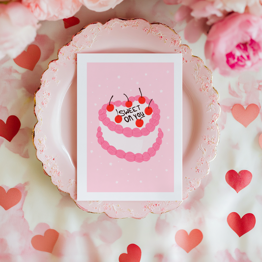 A card with a pink and white cake, saying 'Sweet on you' on the top.