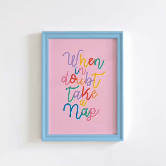 A fun quote print with text saying when in doubt take a nap, on a pink background.