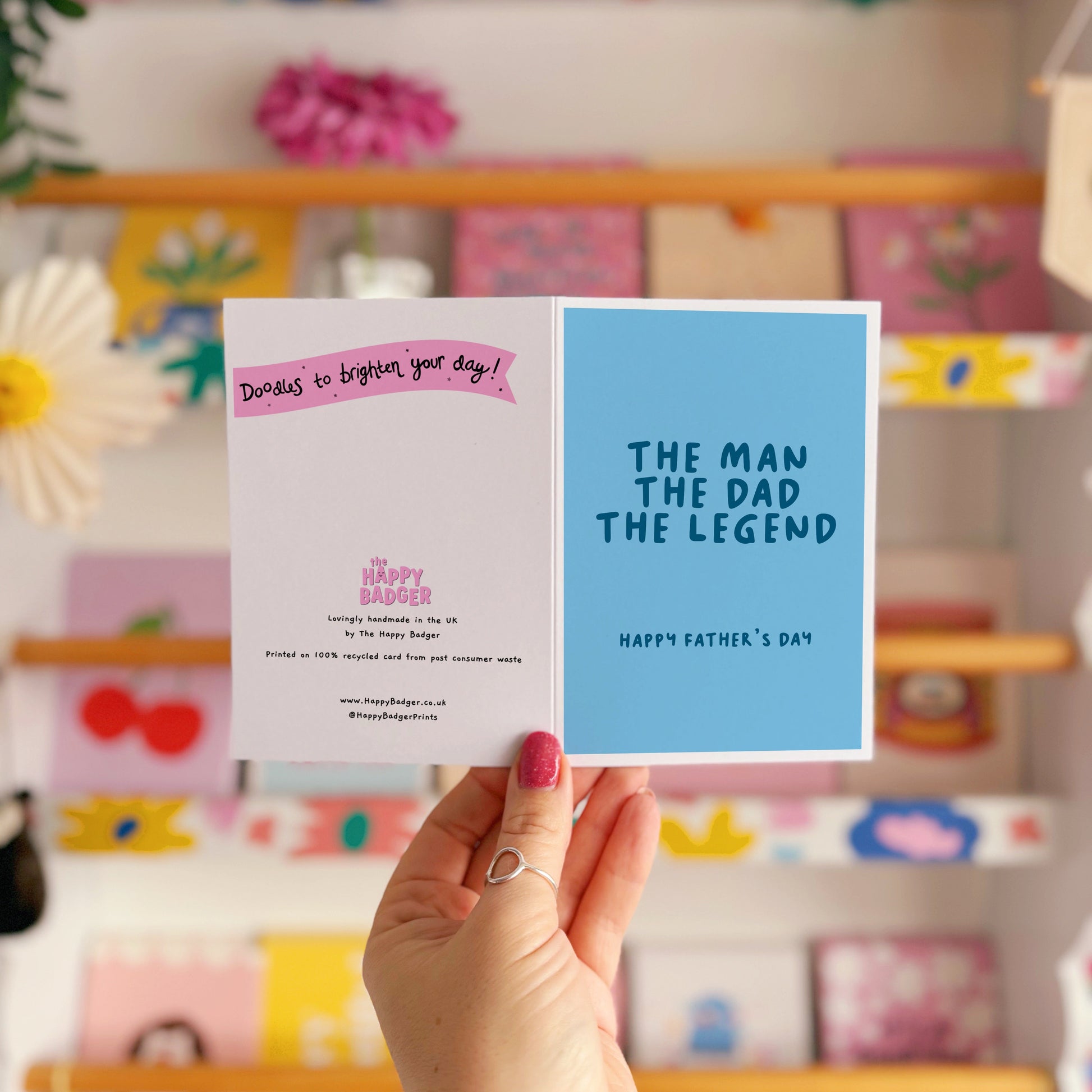 A blue card with text that reads 'the man the dad the legend, happy fathers day'.