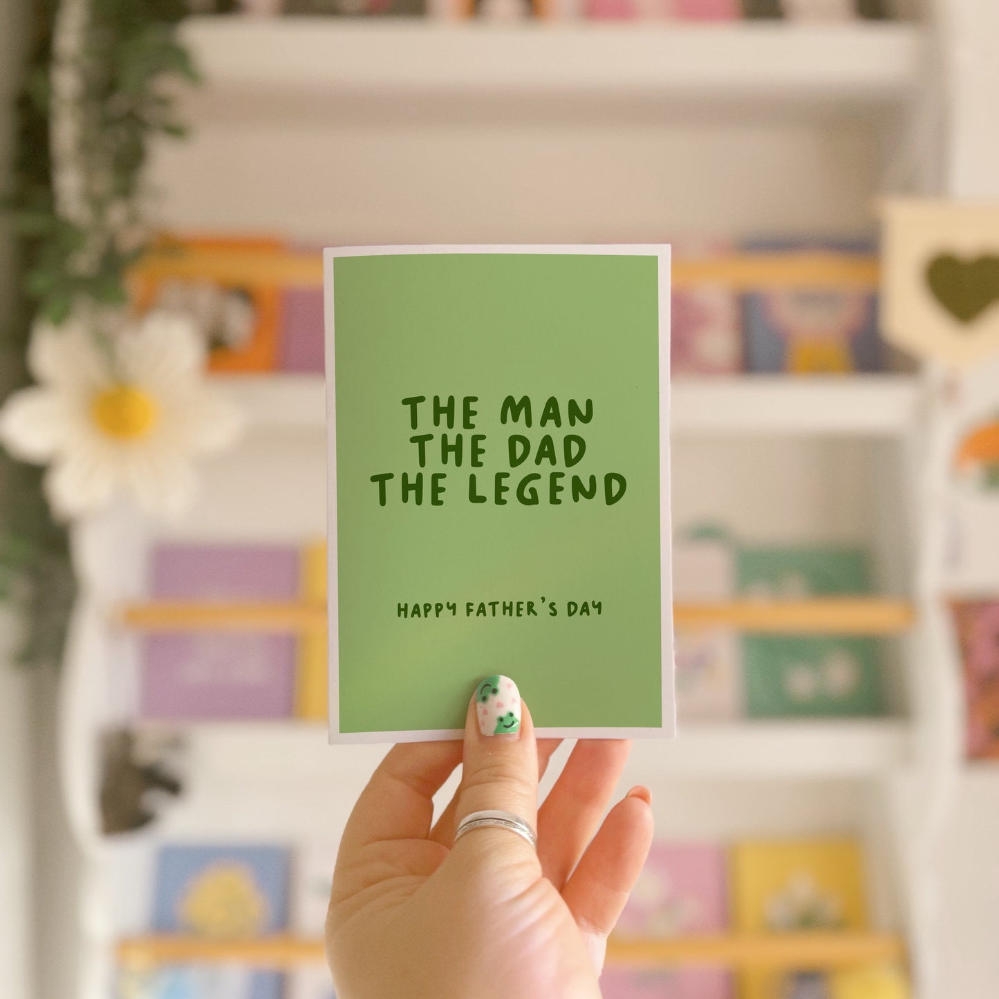A green card with text that reads 'the man the dad the legend. Happy Fathers Day'.