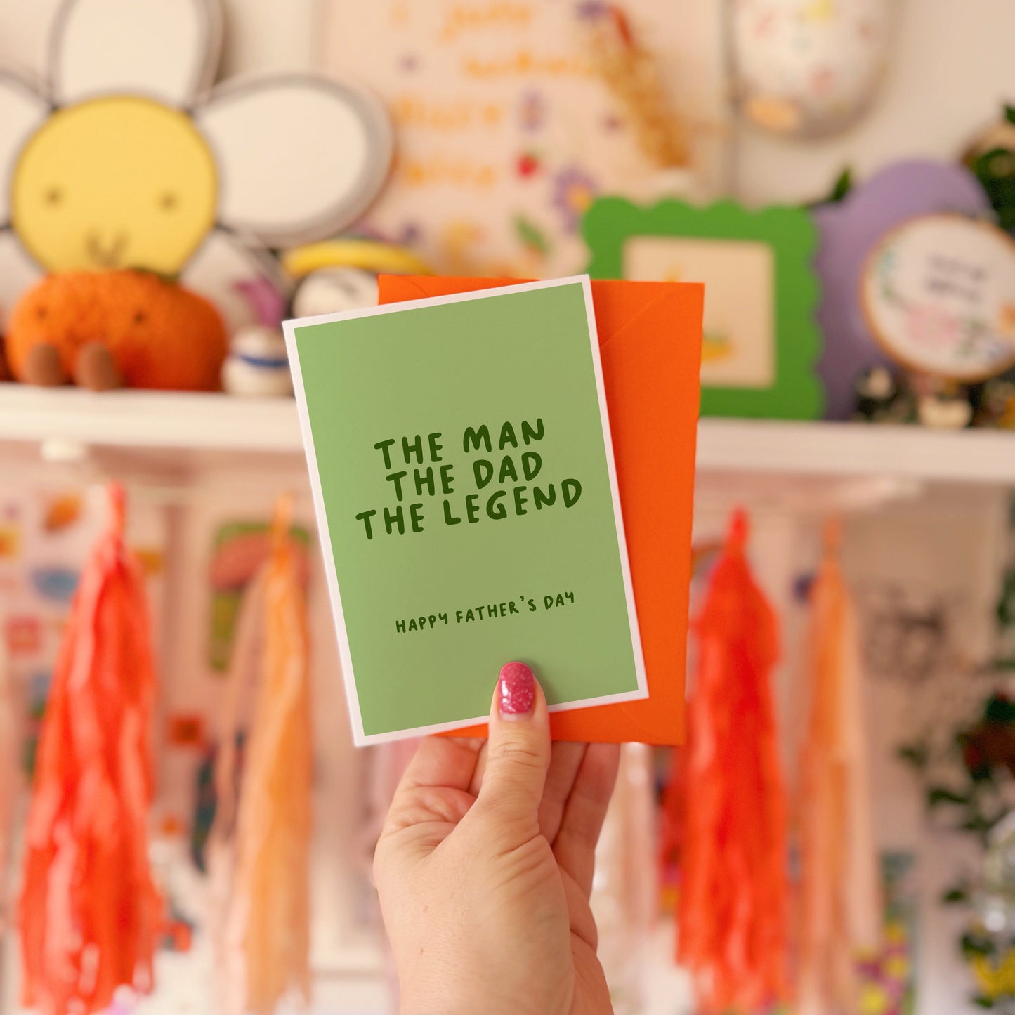 A green card with text that reads 'the man the dad the legend. Happy Fathers Day'.