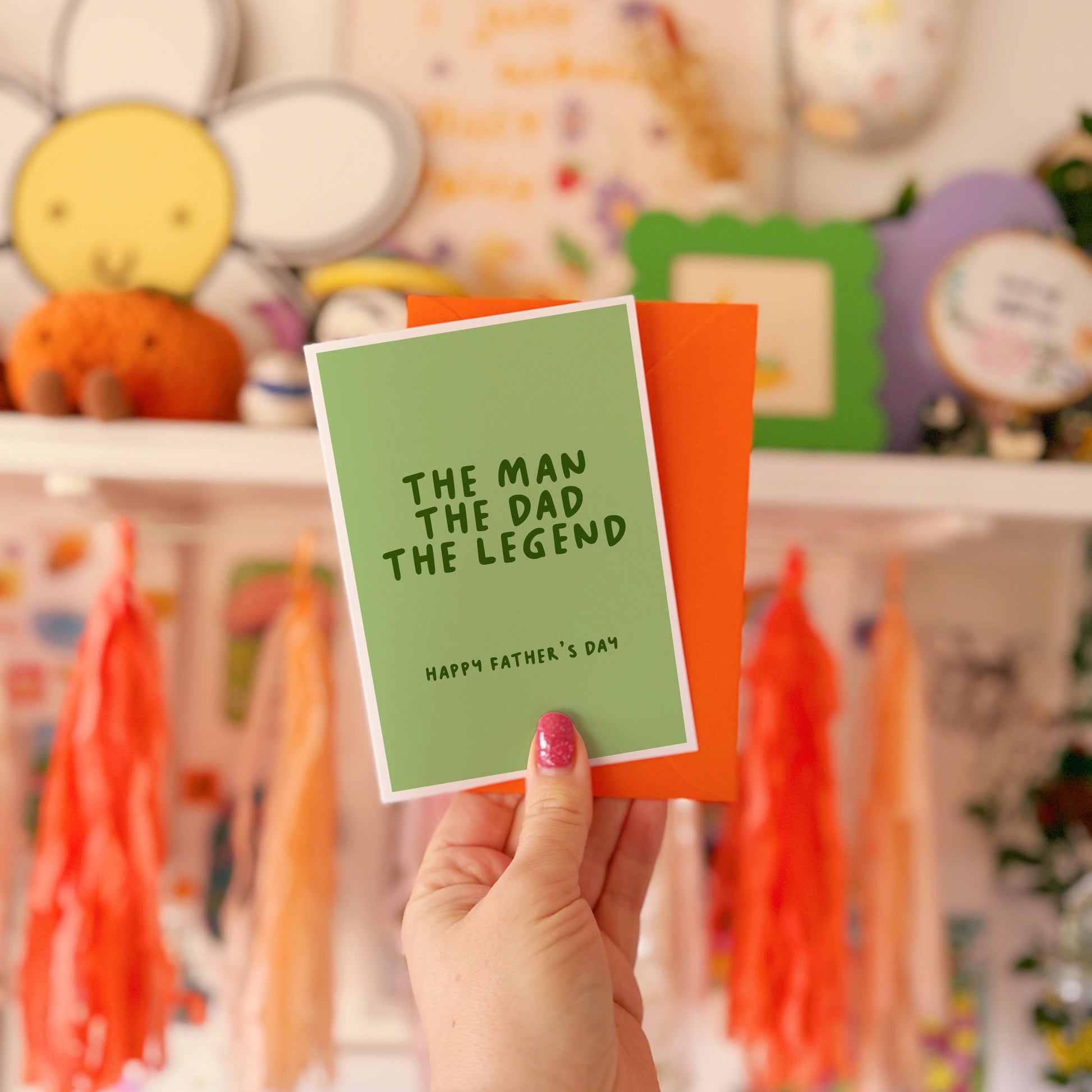 A green card with text that reads 'the man the dad the legend. Happy Fathers Day'.