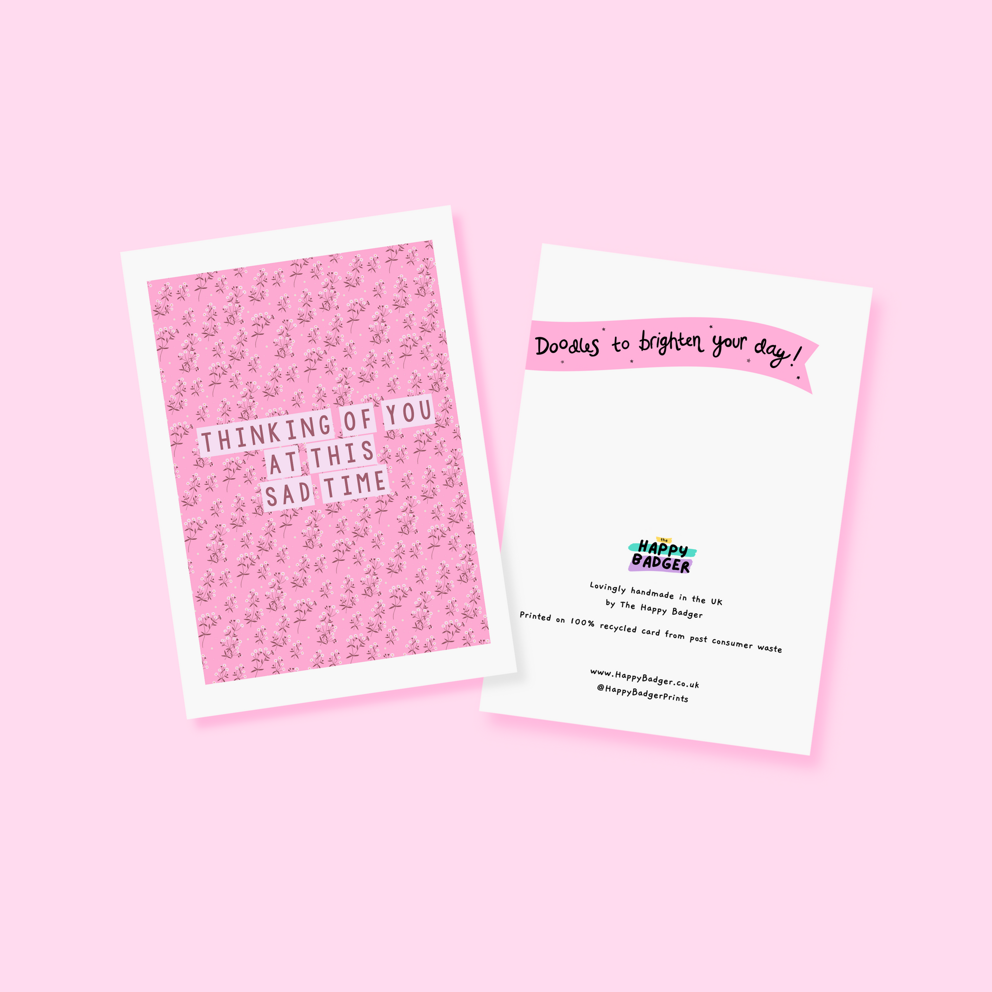 A card with a pink floral patterned background, and the words 'thinking of you at this sad time' in the centre.