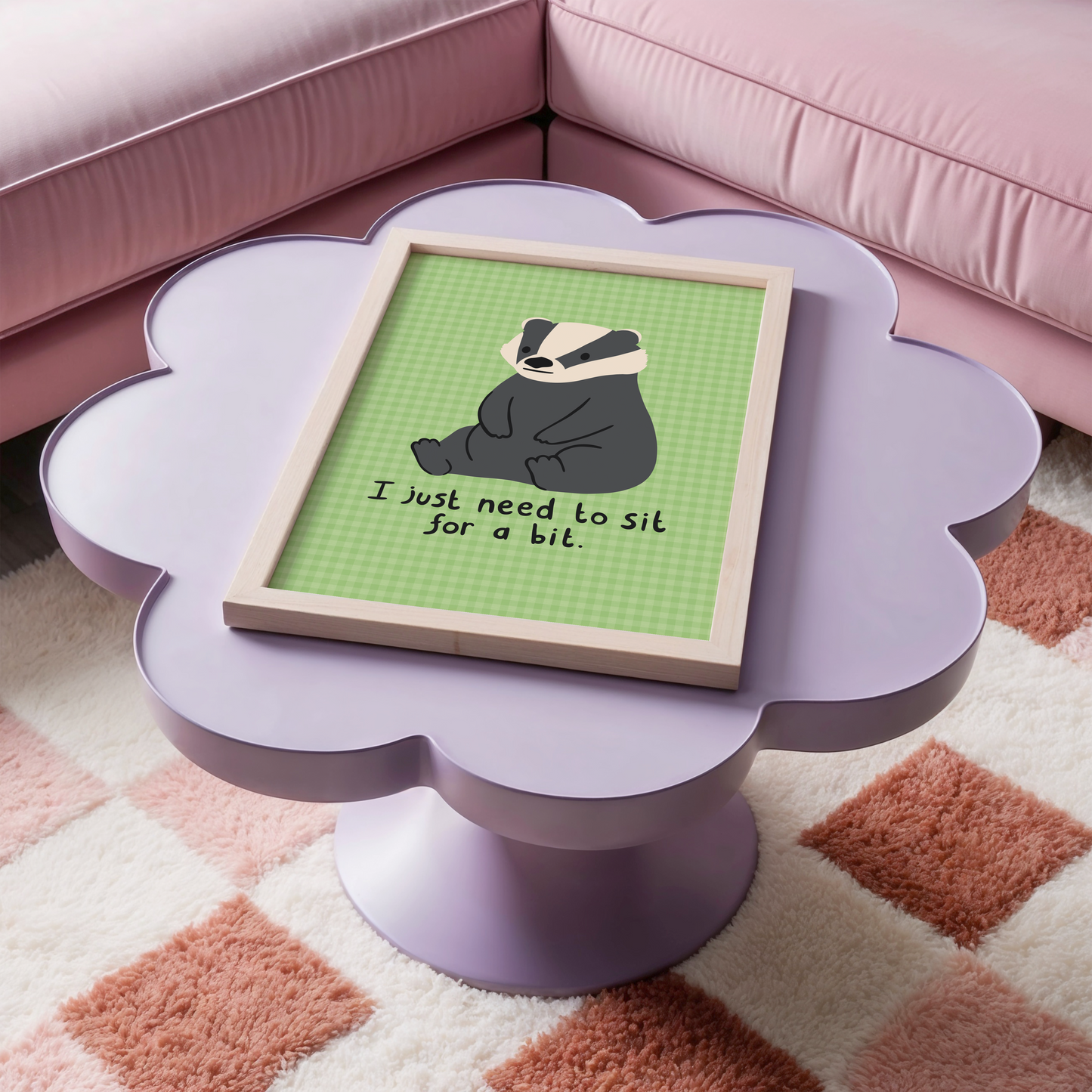 A green gingham print, with an illustration of a badger sat down, and a quote that reads 'I just need to sit for a bit'.