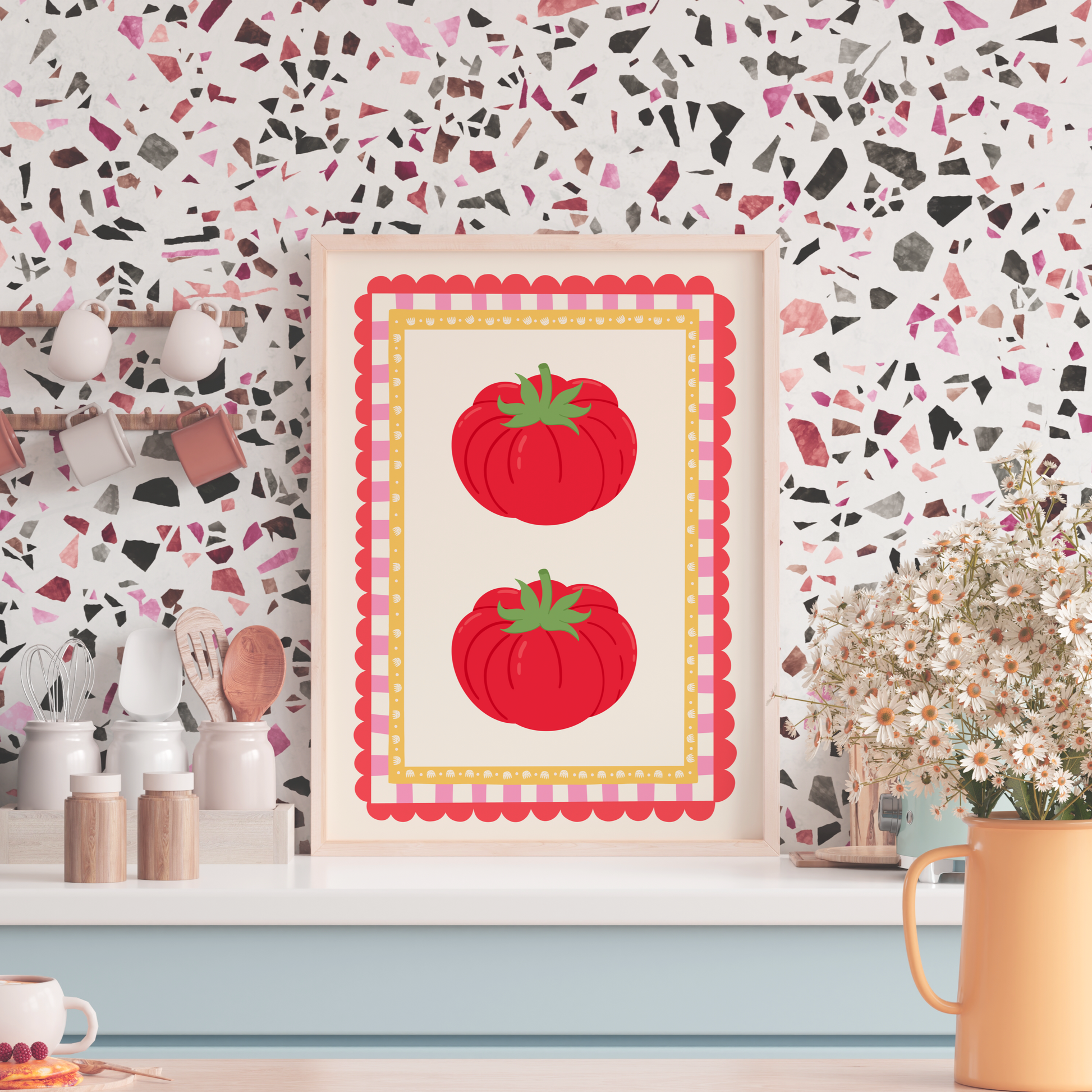 Kitchen counter with a decorative print of red tomatoes on a colorful wall.