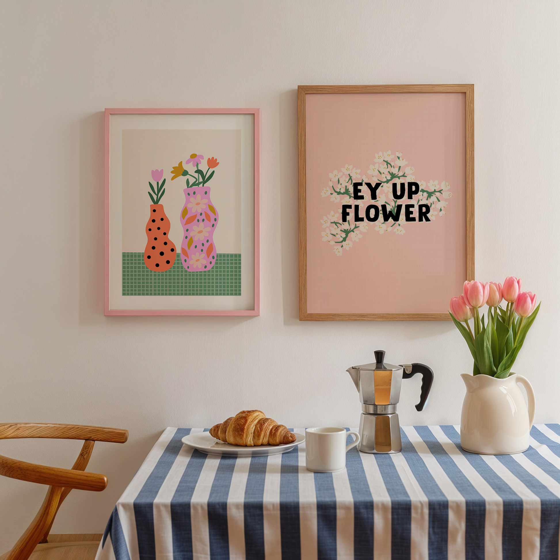 A pink print with a floral illustration, on top of which is the quote 'Ey Up Flower' in black text. Shown next to a vibrant vases print, in shades of pink orange and green.