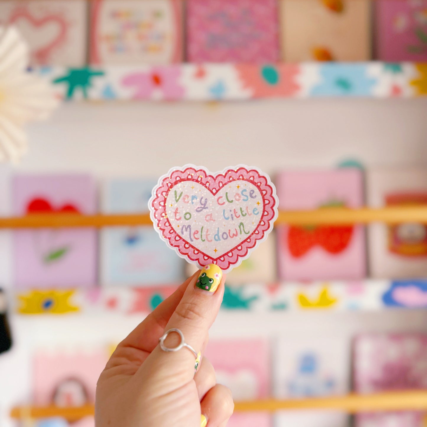 A scalloped edge heart, with hand lettered quote in the centre that reads 'very close to a little meltdown'.