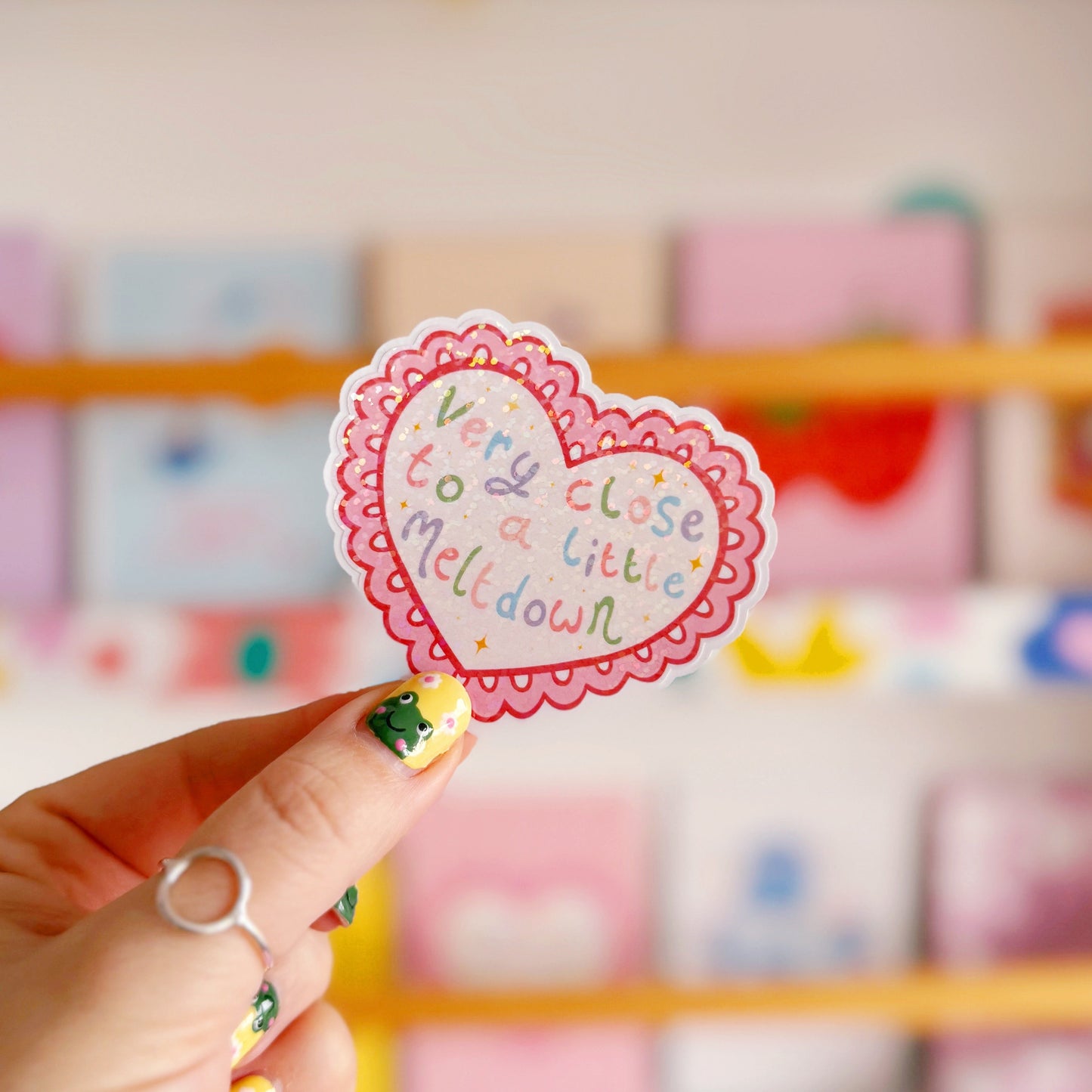 A scalloped edge heart, with hand lettered quote in the centre that reads 'very close to a little meltdown'.