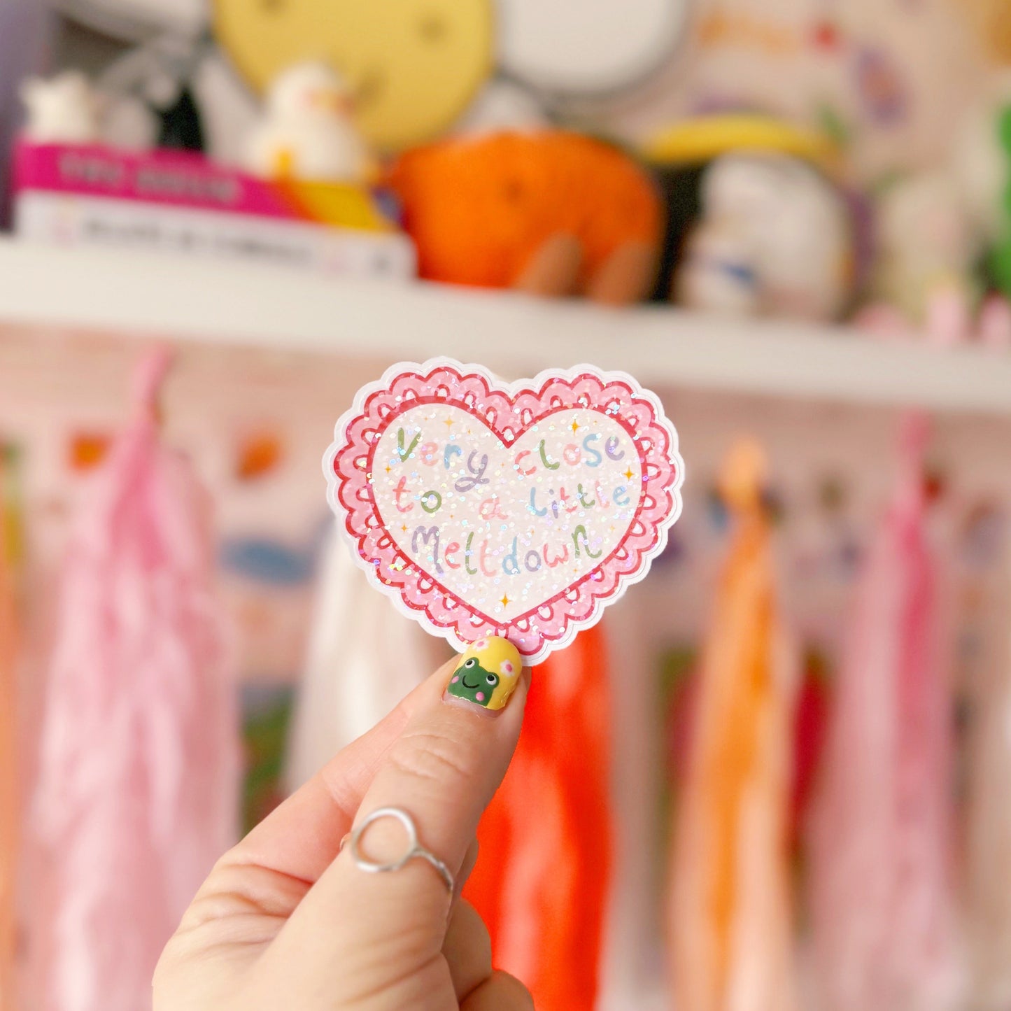 A scalloped edge heart, with hand lettered quote in the centre that reads 'very close to a little meltdown'.