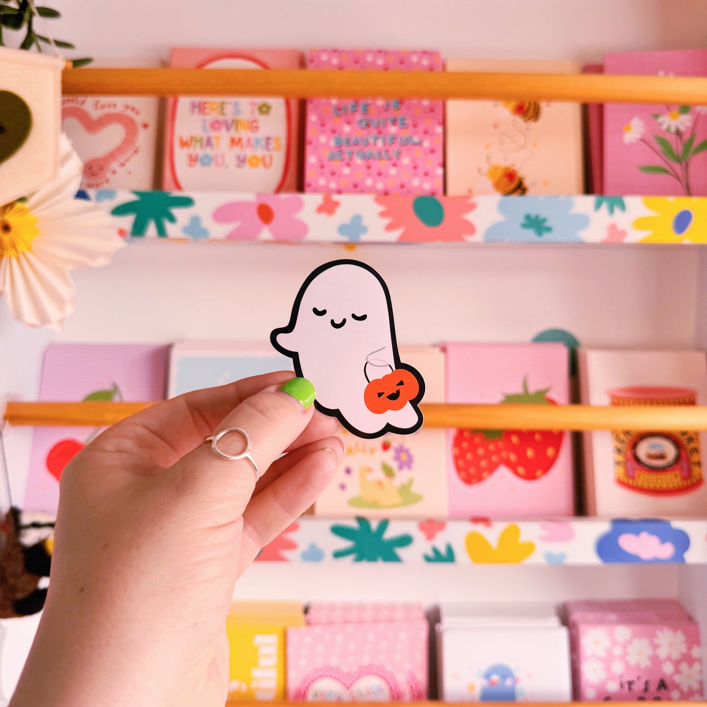 A cute smiling ghost sticker, with a black outline. 