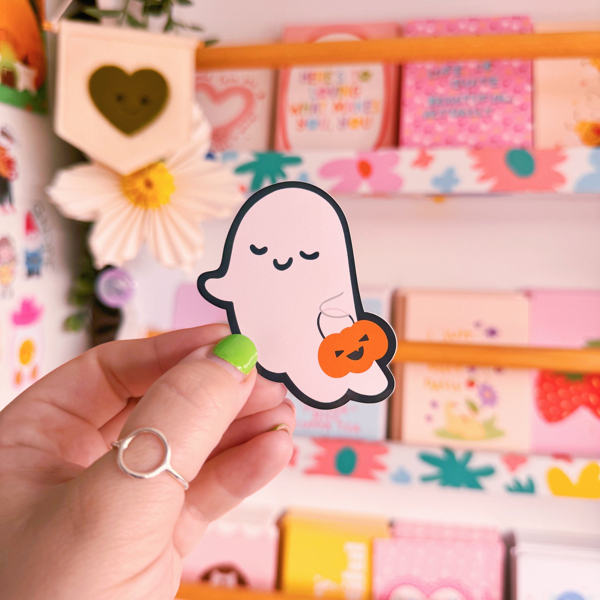 A cute smiling ghost sticker, with a black outline. 