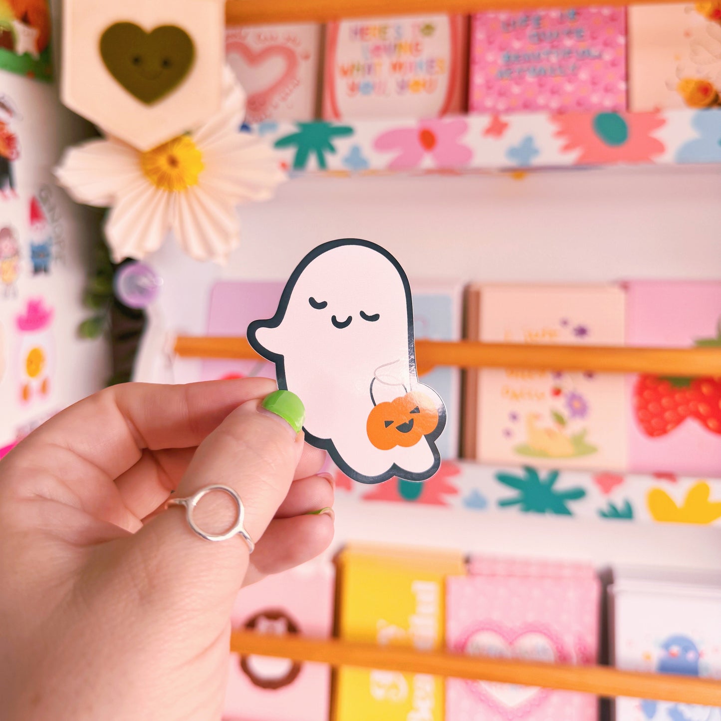 A cute smiling ghost sticker, with a black outline. 