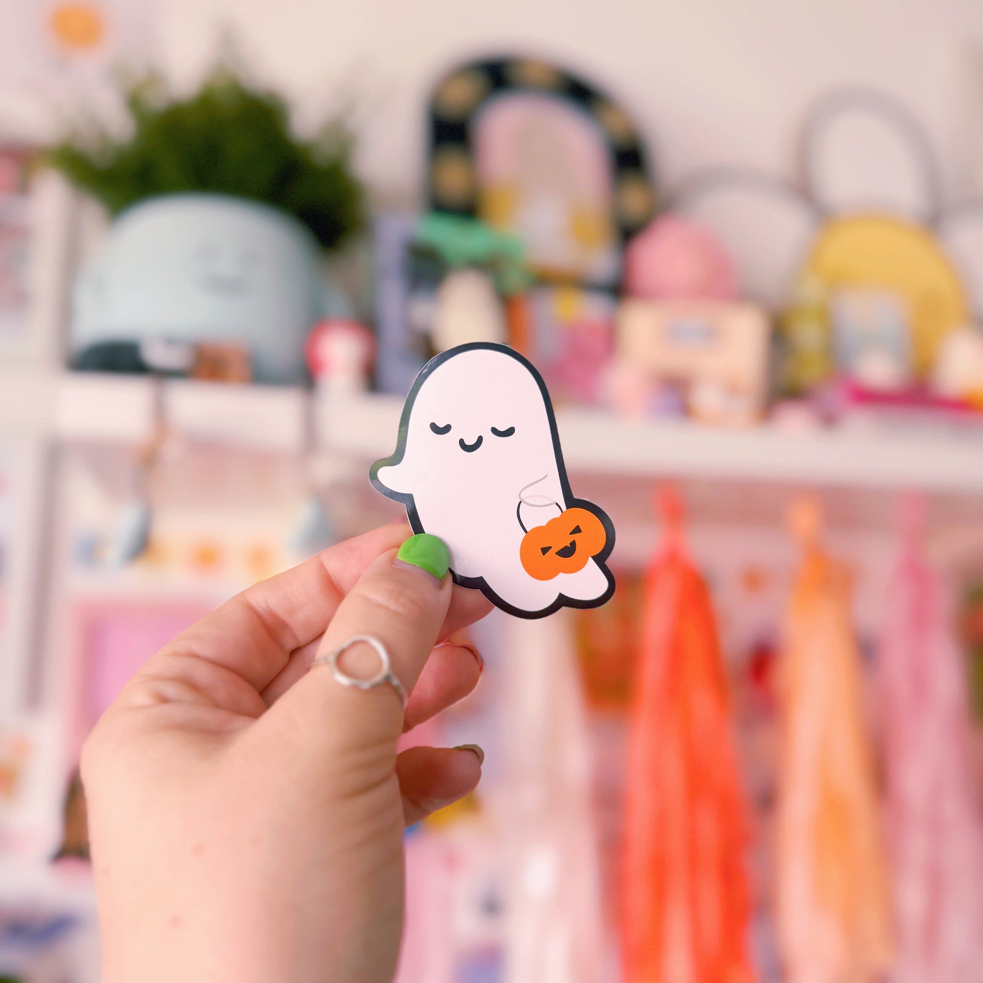 A cute smiling ghost sticker, with a black outline. 