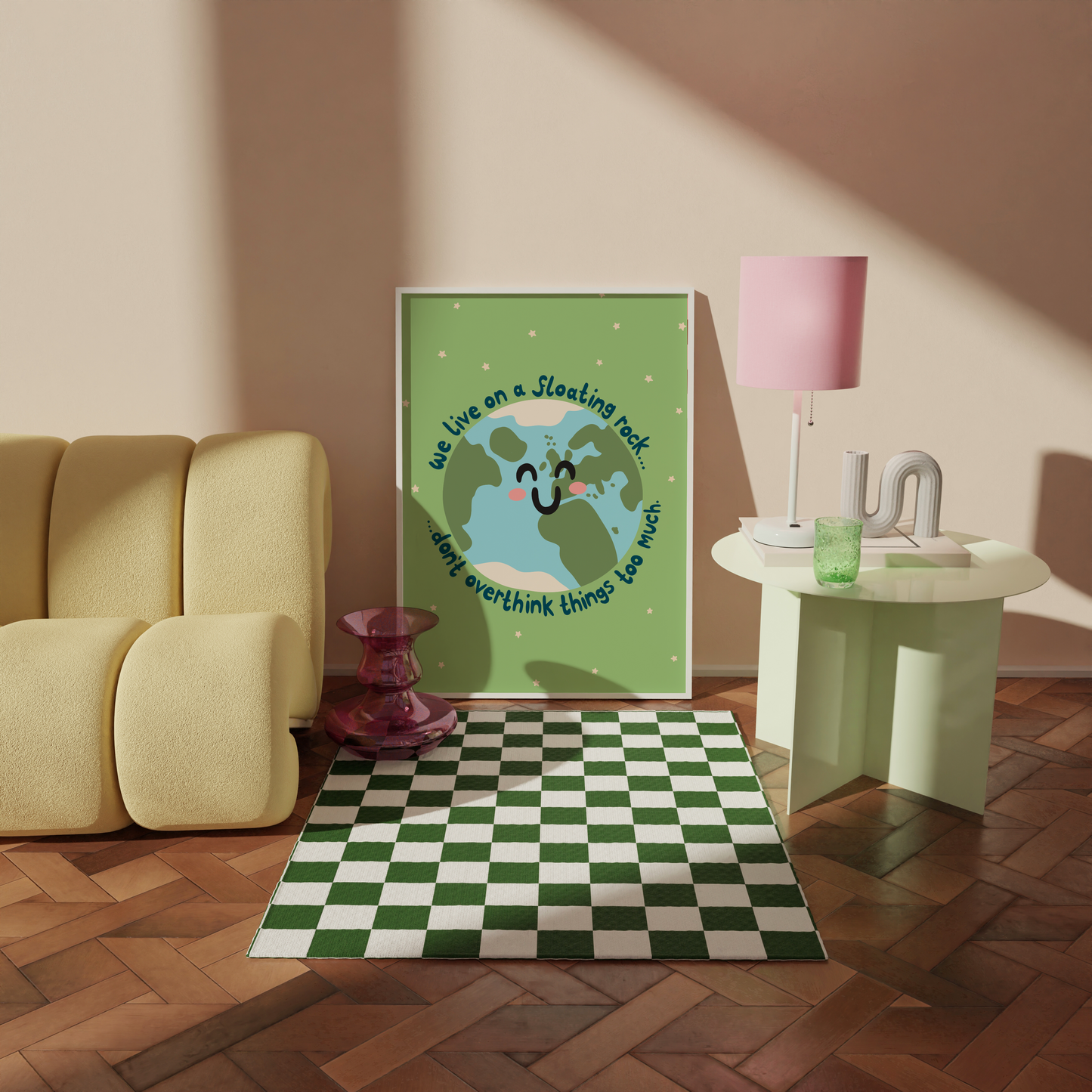 A green print with an illustration of a smiling planet earth. Around the earth is text that reads 'we live on a floating rock... don't overthink things too much.'