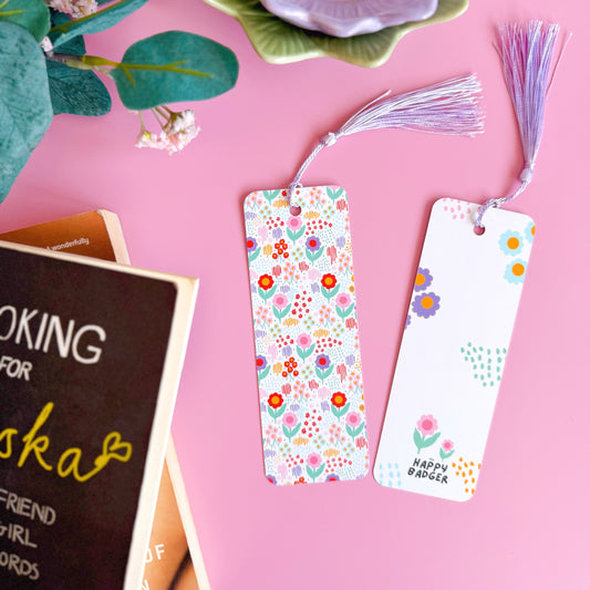 A brightly patterned floral bookmark with a coordinating purple tassel.