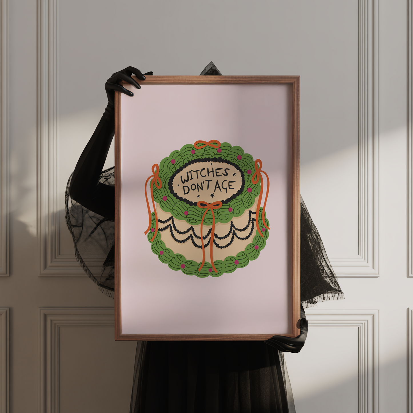 A Halloween print featuring an illustration of a cake, with green, orange and black icing. The words on top of the cake read 'witches don't age'.