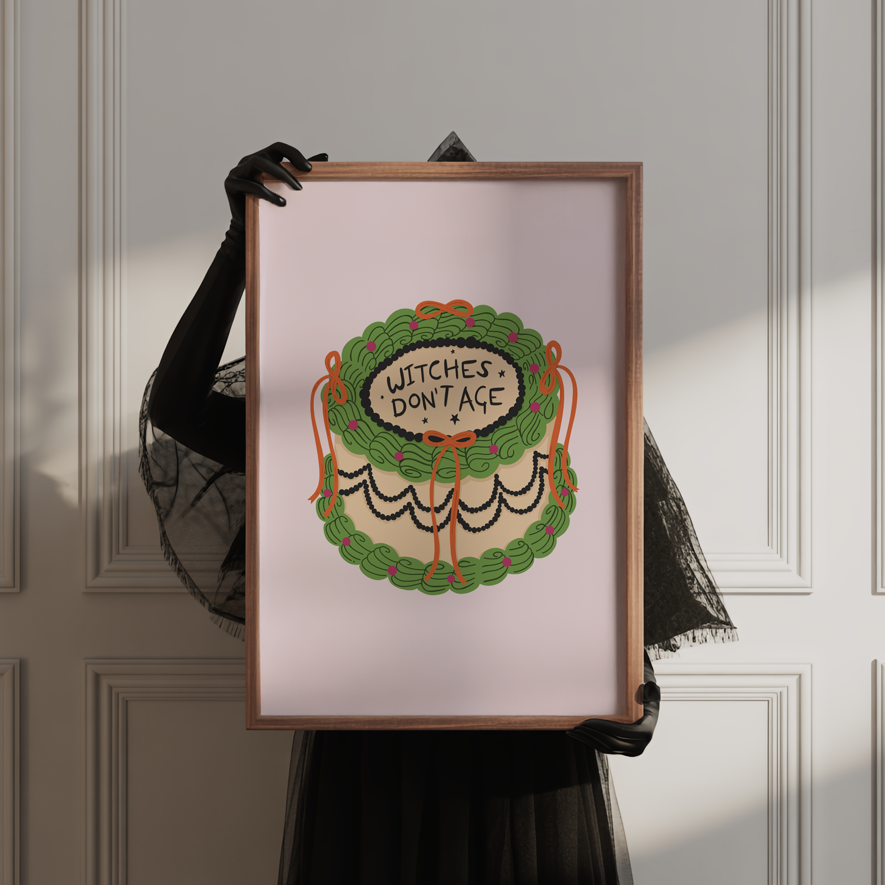 A Halloween print featuring an illustration of a cake, with green, orange and black icing. The words on top of the cake read 'witches don't age'.