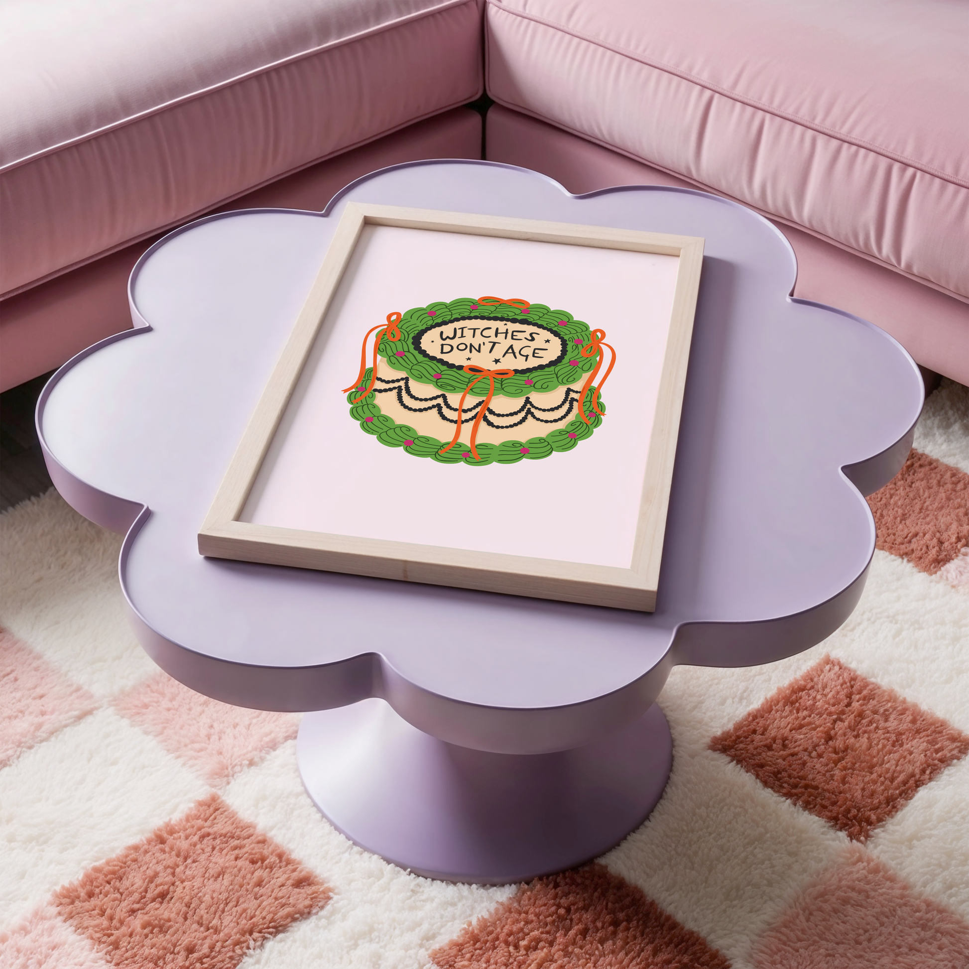 A Halloween print featuring an illustration of a cake, with green, orange and black icing. The words on top of the cake read 'witches don't age'.