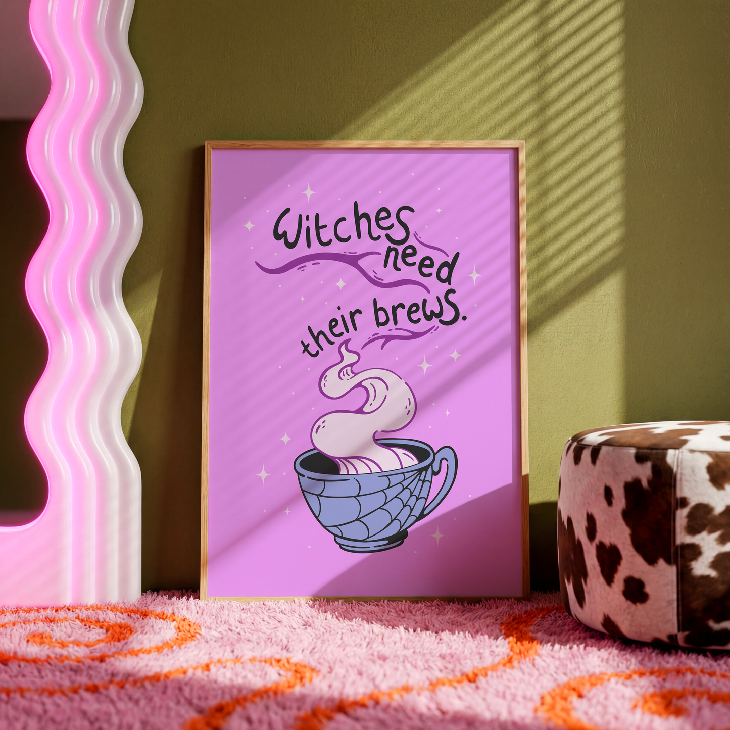 A purple Halloween illustration print, that features a spooky mug with steam coming out of it. Within the steam are the words 'witches need their brews'.
