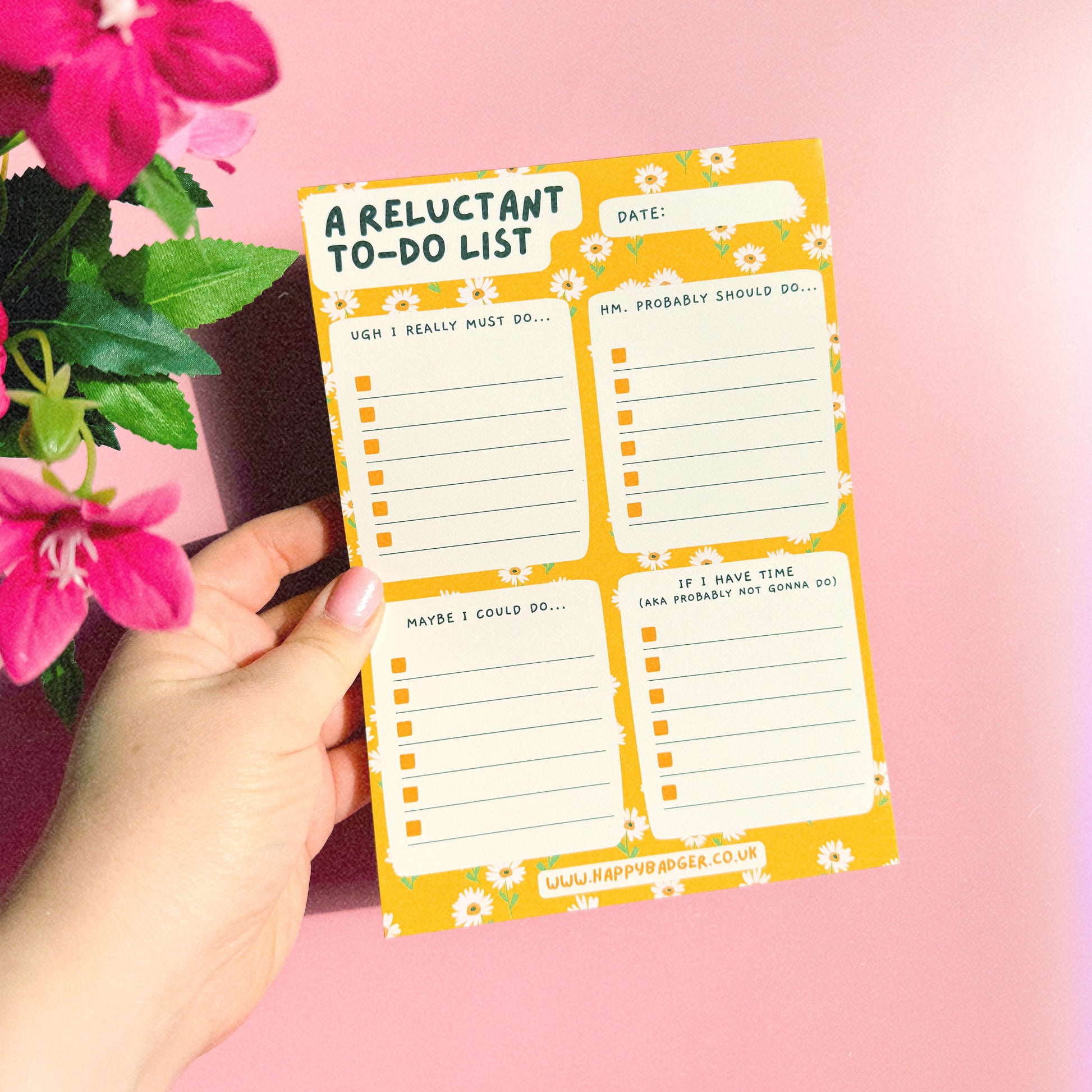 An image of an A5 yellow notepad, with funny headed sections. The notepad has a yellow floral background and four sections.