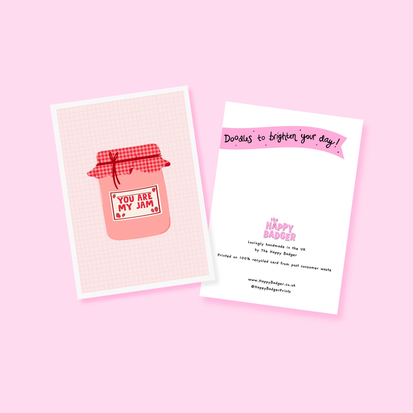A greeting card with an illustration of a jam jar, with 'you are my jam' written on the label. The jam jar has a red and pink gingham lid and the label is decorated with strawberry doodles.