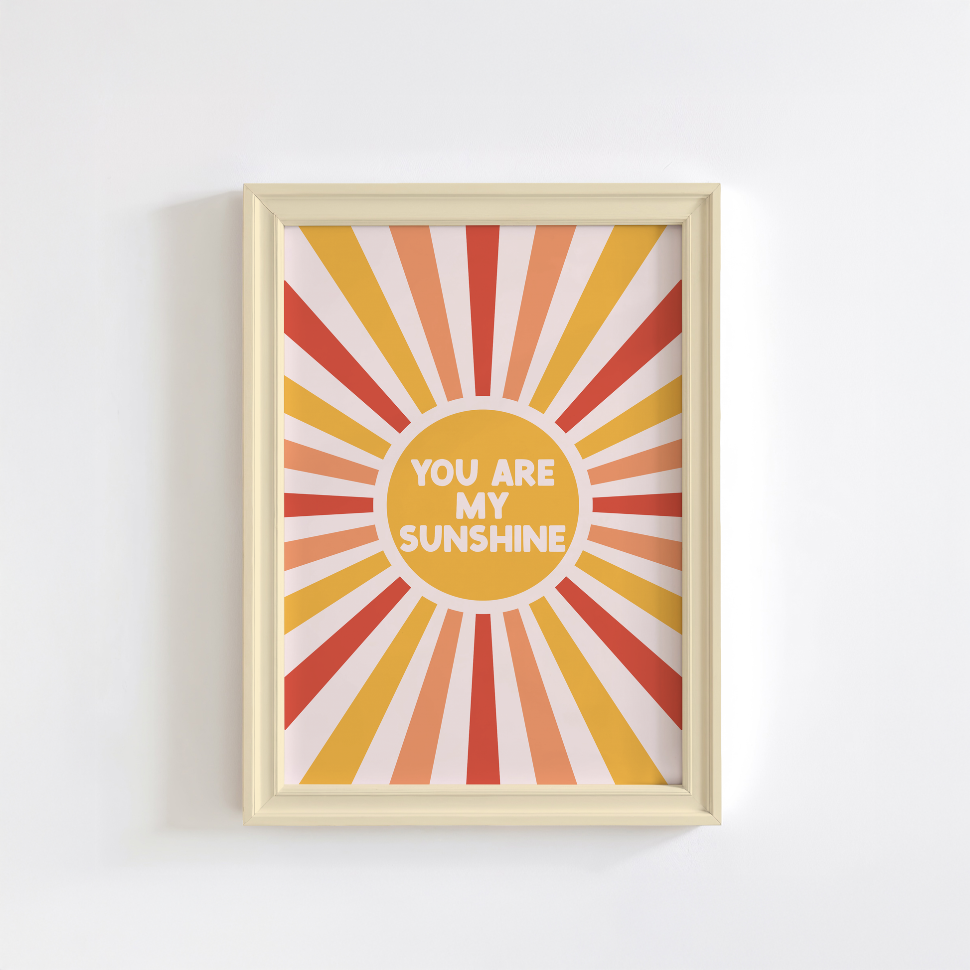 A fun quote print with text saying you are my sunshine, on a star burst background in orange yellow and red.