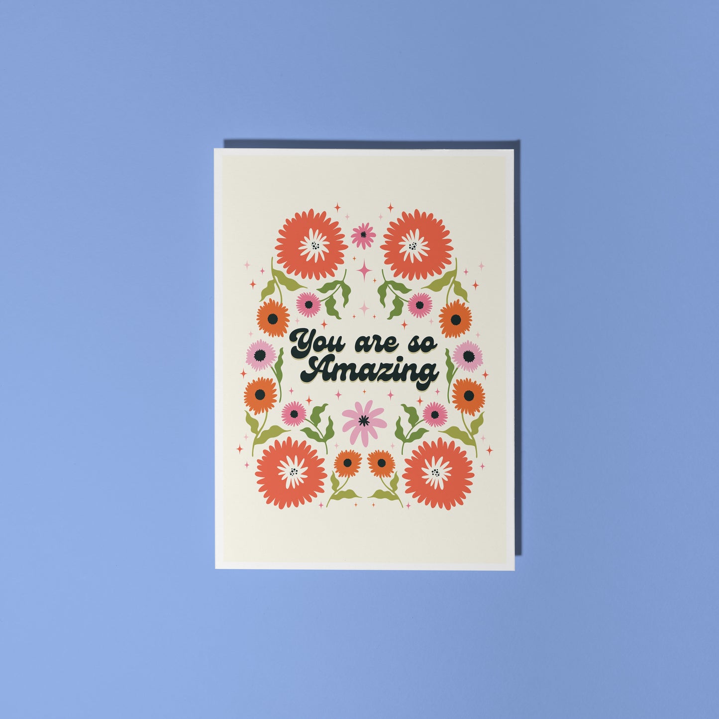 Hand holding a thank you card with 'You are so amazing' written on the front and floral detailing.