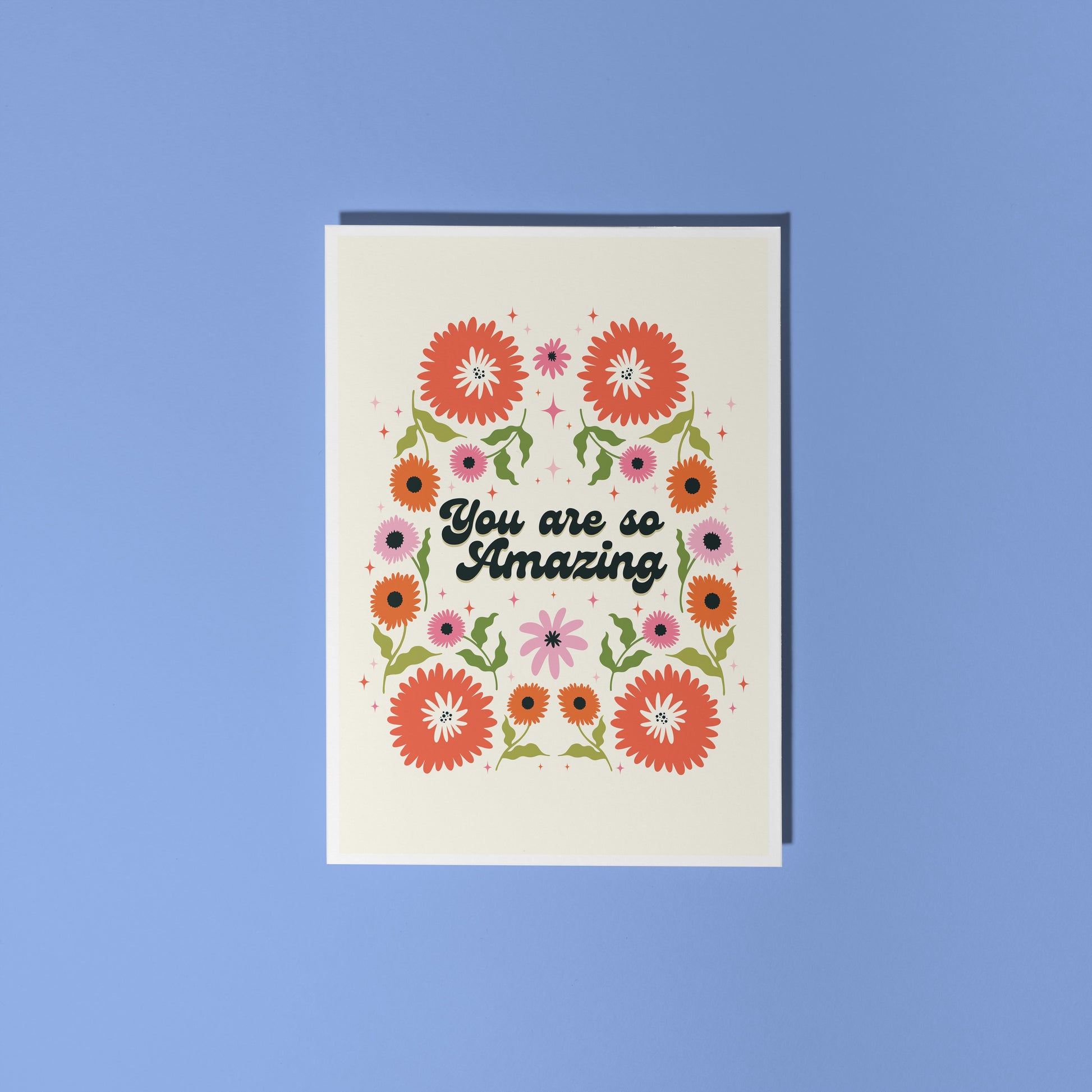 Hand holding a thank you card with 'You are so amazing' written on the front and floral detailing.