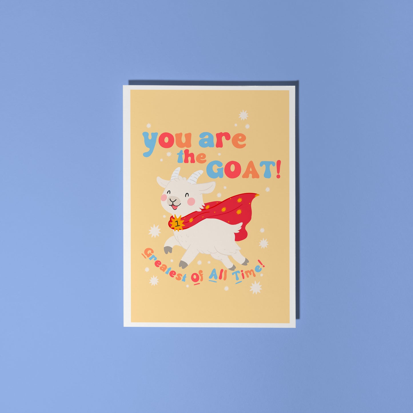 A greetings card with a goat illustration, and hand lettered text that reads 'you are the goat! (greatest of all time!)'.