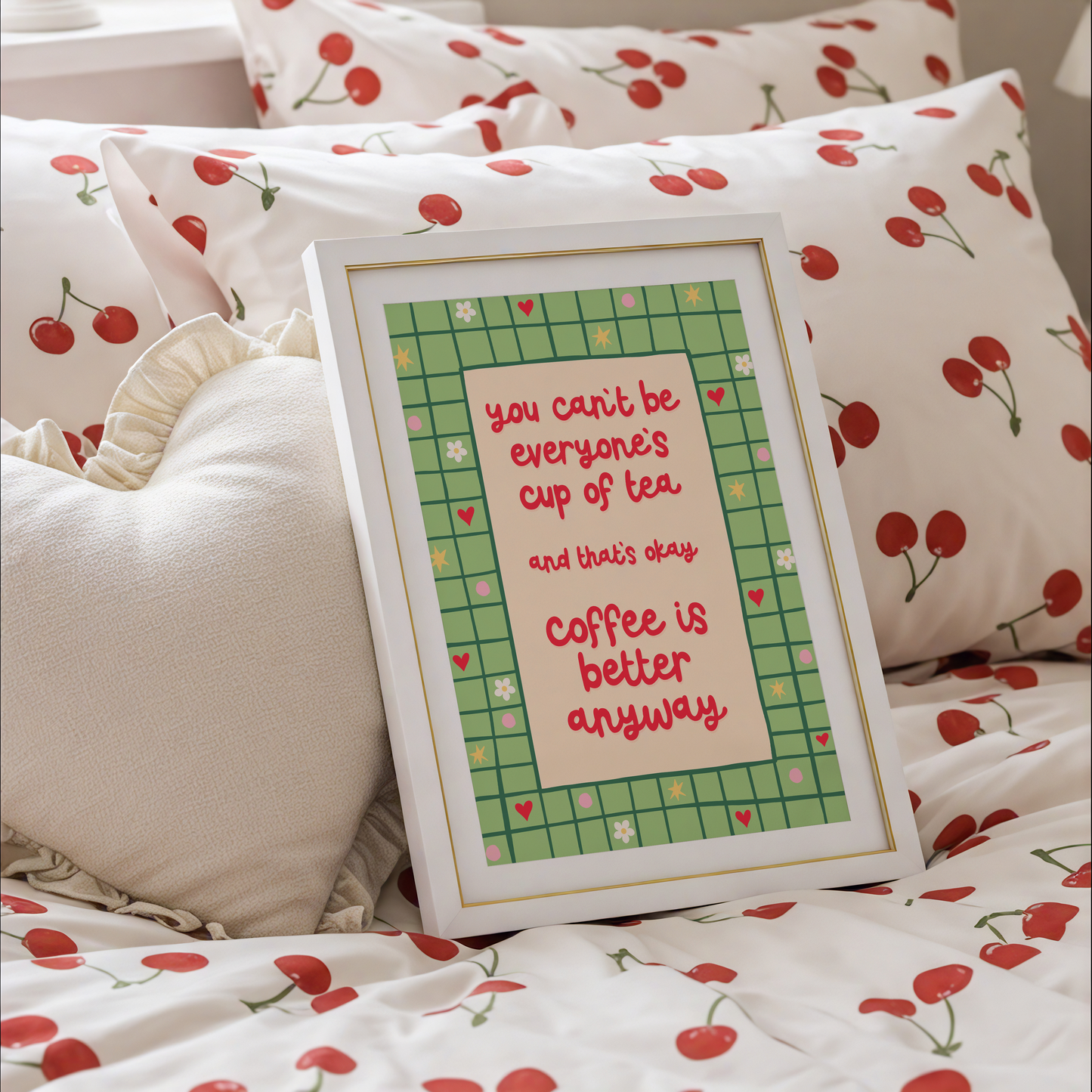 A green bordered print, with little doodles within the border, and a quote in red that reads 'you can't be everyone's cup of tea and that's okay. coffee is better anyway'.