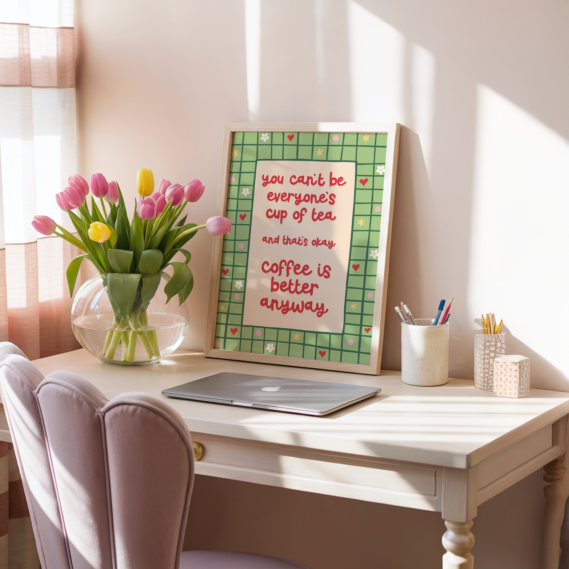 A green bordered print, with little doodles within the border, and a quote in red that reads 'you can't be everyone's cup of tea and that's okay. coffee is better anyway'.