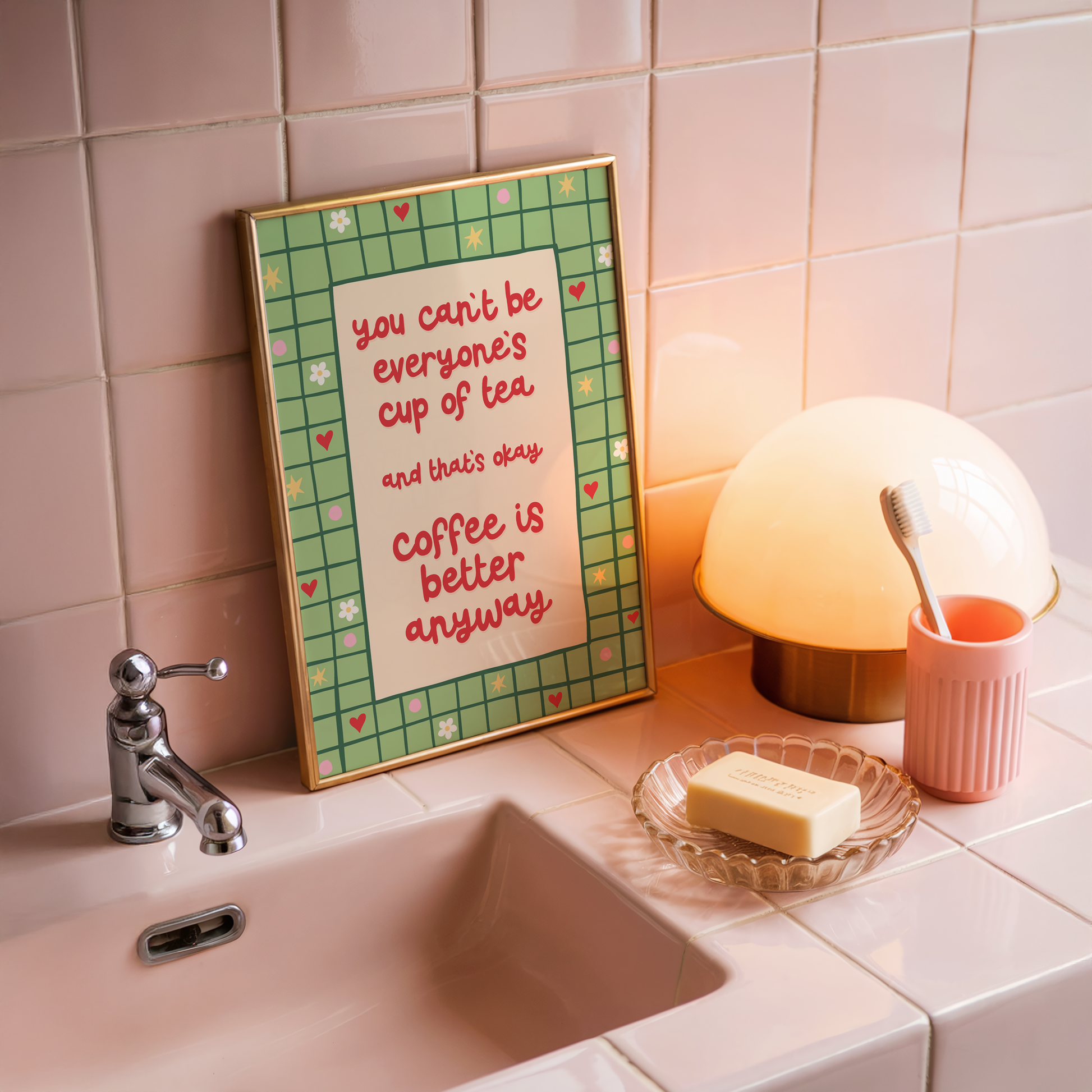 A green bordered print, with little doodles within the border, and a quote in red that reads 'you can't be everyone's cup of tea and that's okay. coffee is better anyway'.