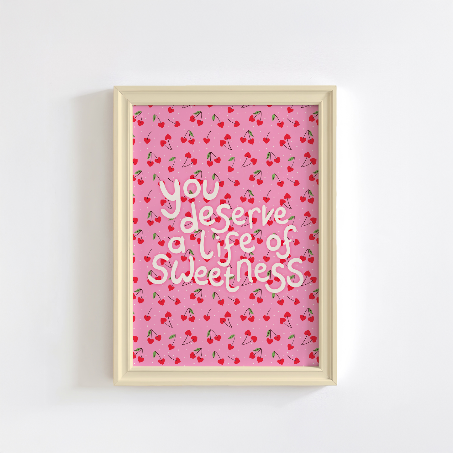 Decorative wall art with a heart shaped cherry pattern and hand lettered quote.