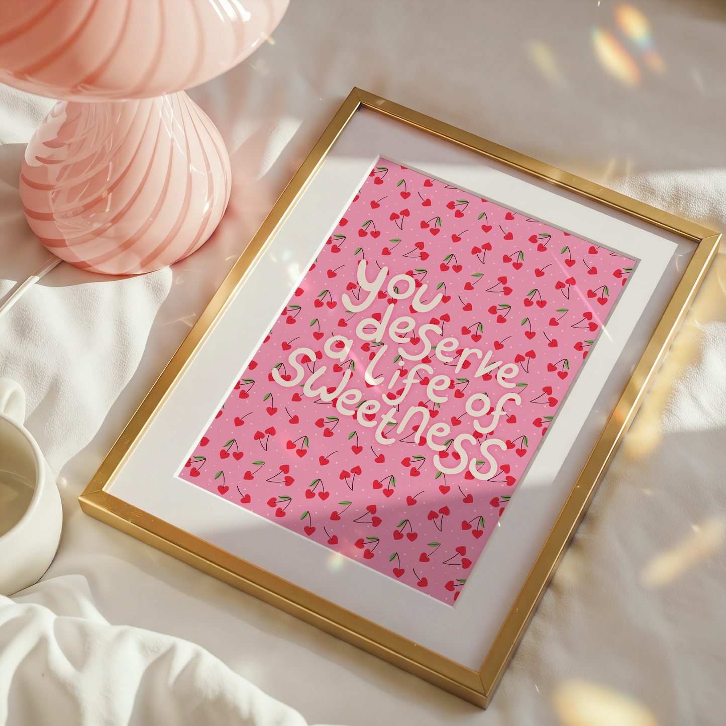 Decorative wall art with a heart shaped cherry pattern and hand lettered quote.