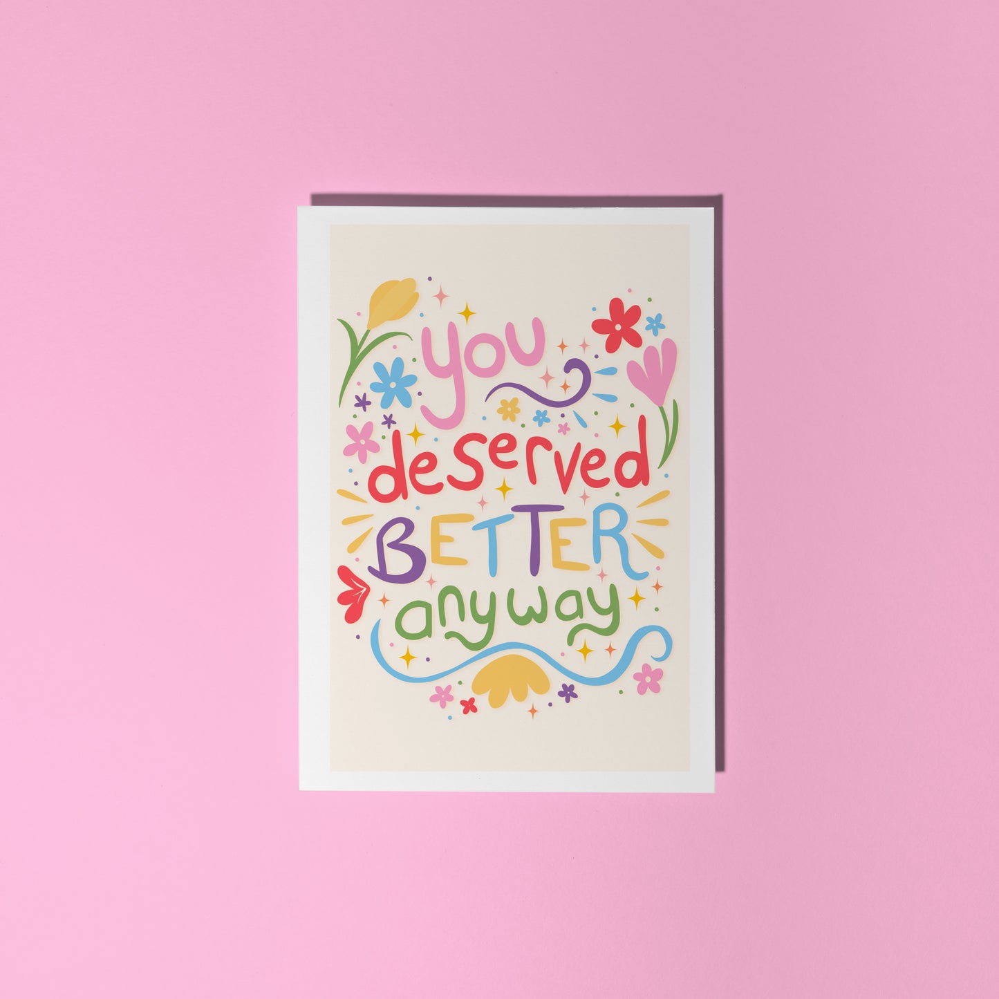 Motivational card with colourful text on a pink background