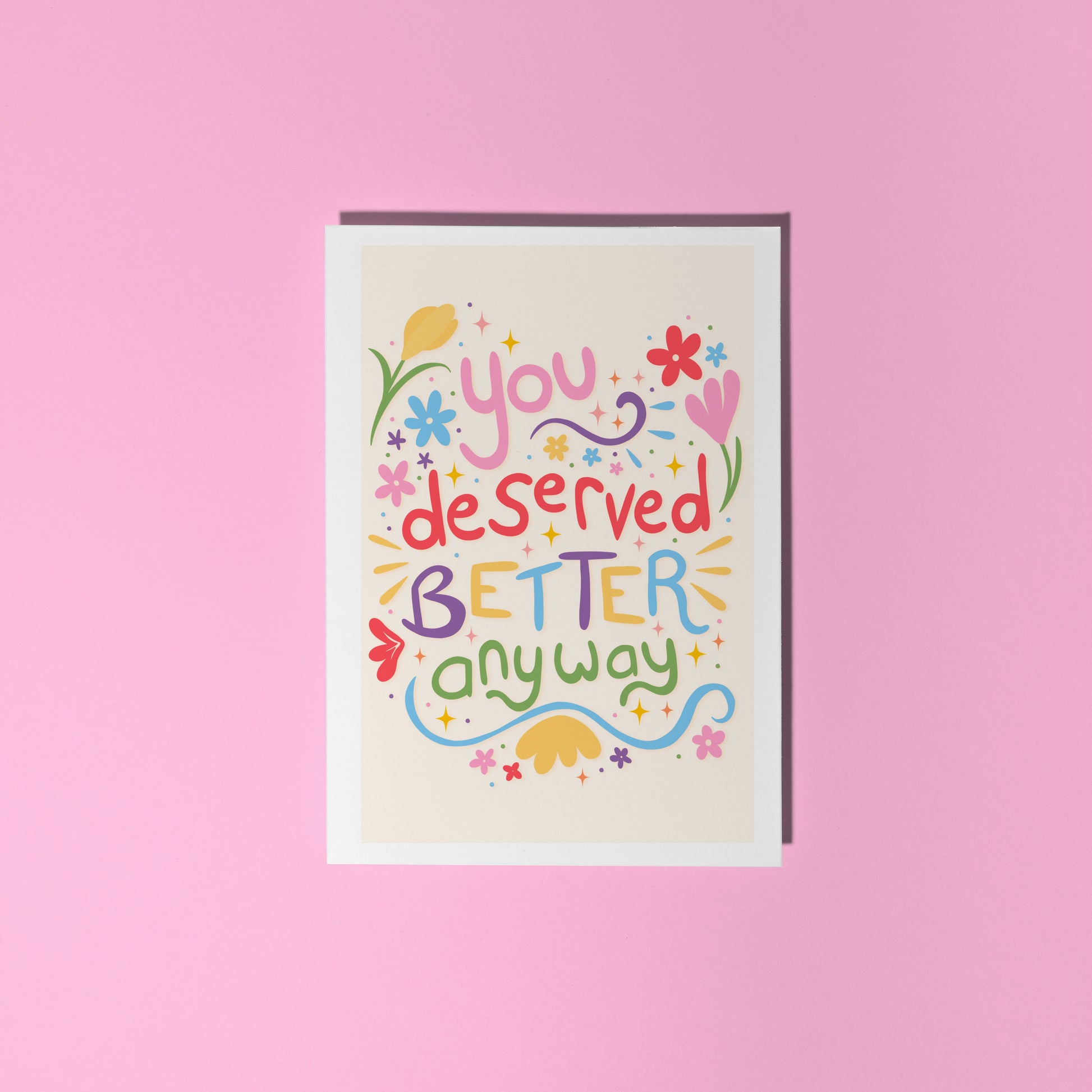 Motivational card with colourful text on a pink background