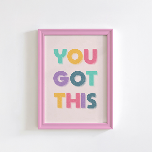 A motivational print with multicoloured lettering, saying You Got This.