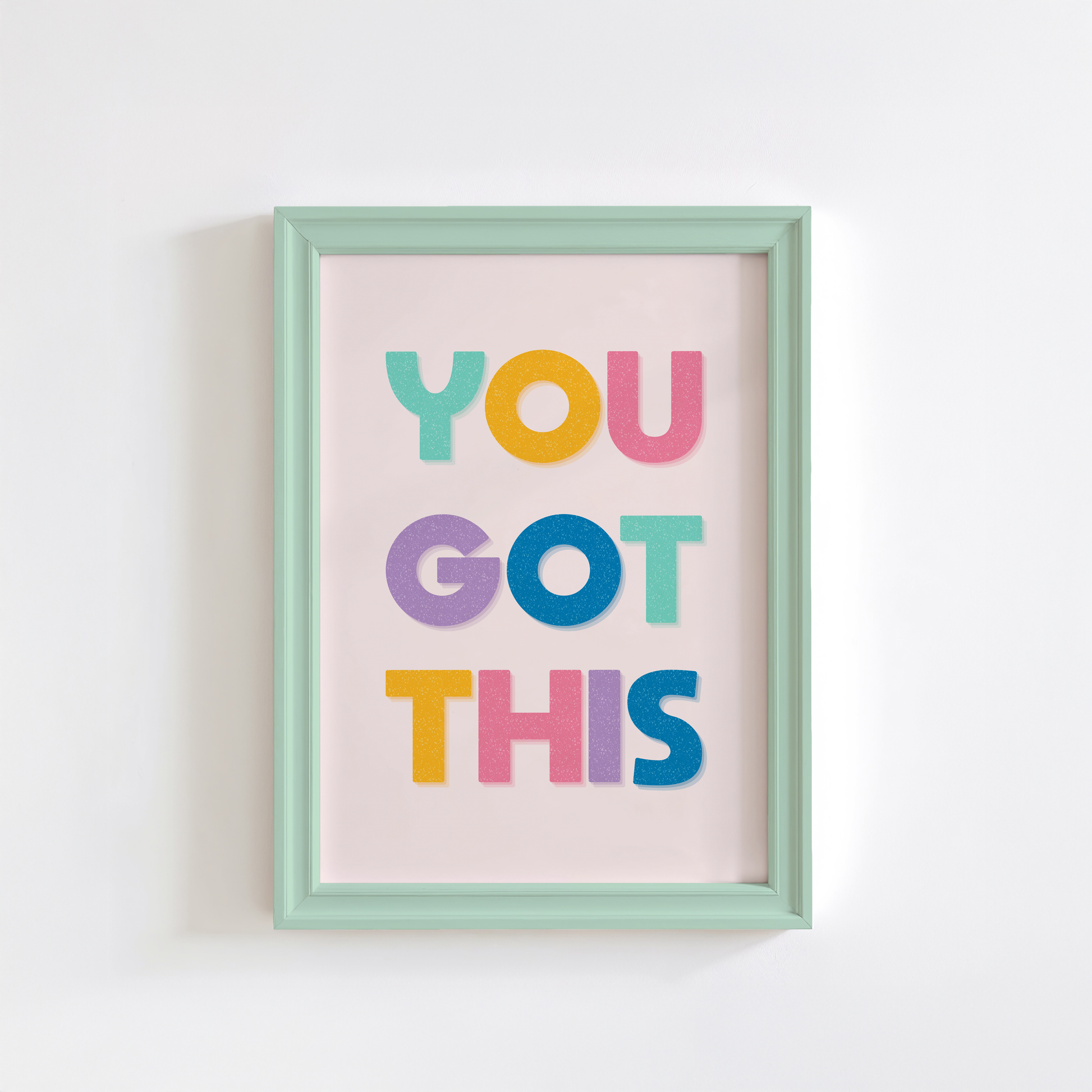 A motivational print with multicoloured lettering, saying You Got This.
