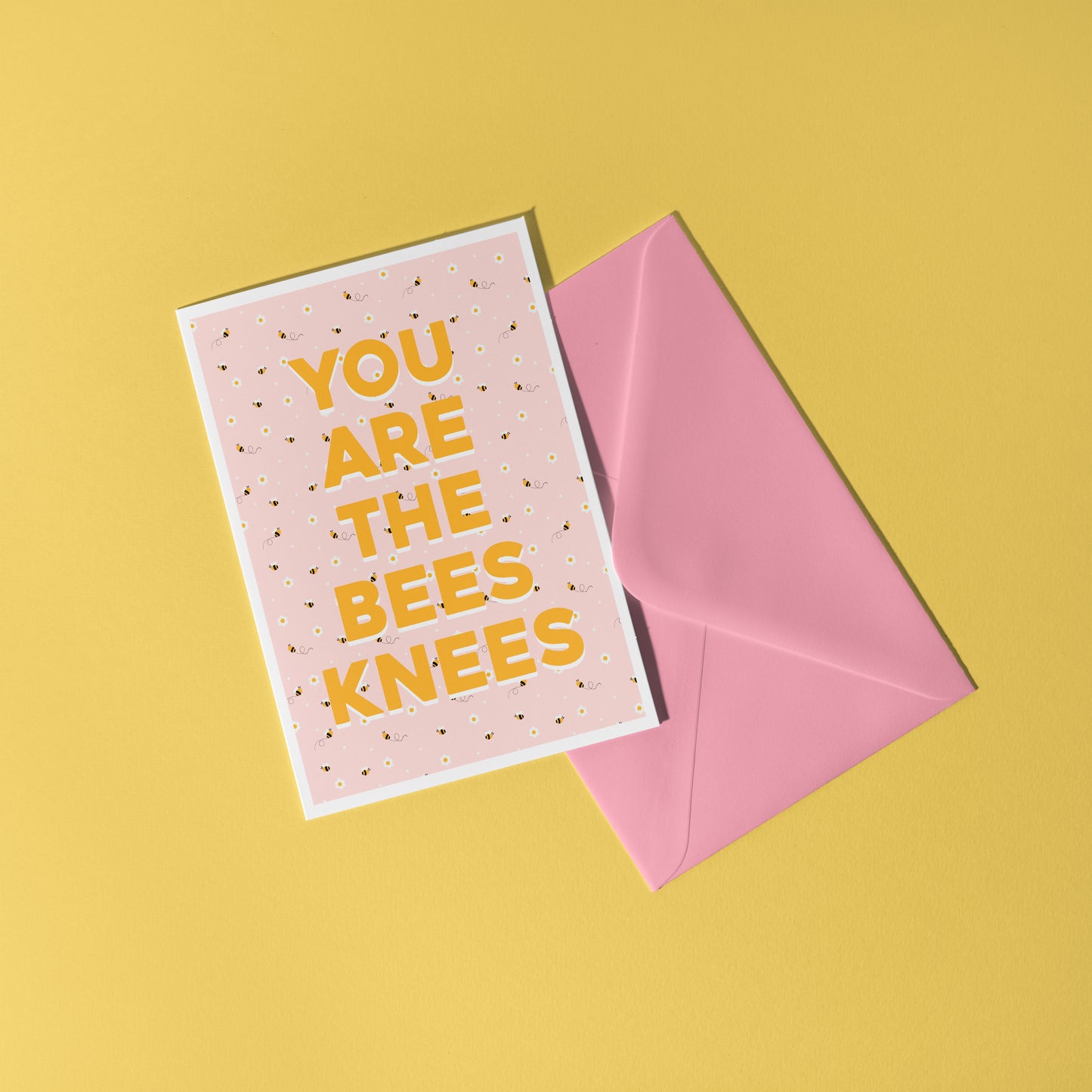 Card with 'YOU ARE THE BEES KNEES' text on a pink background with bee illustrations against a yellow background