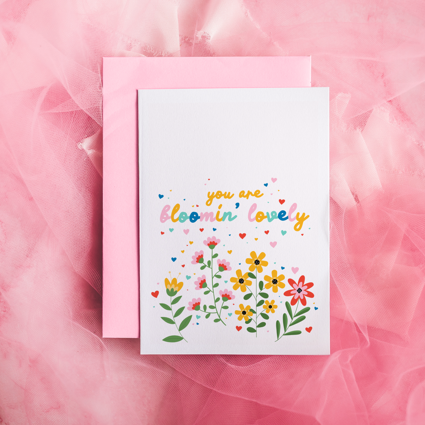 A card with floral illustrations and text that says you are bloomin' lovely