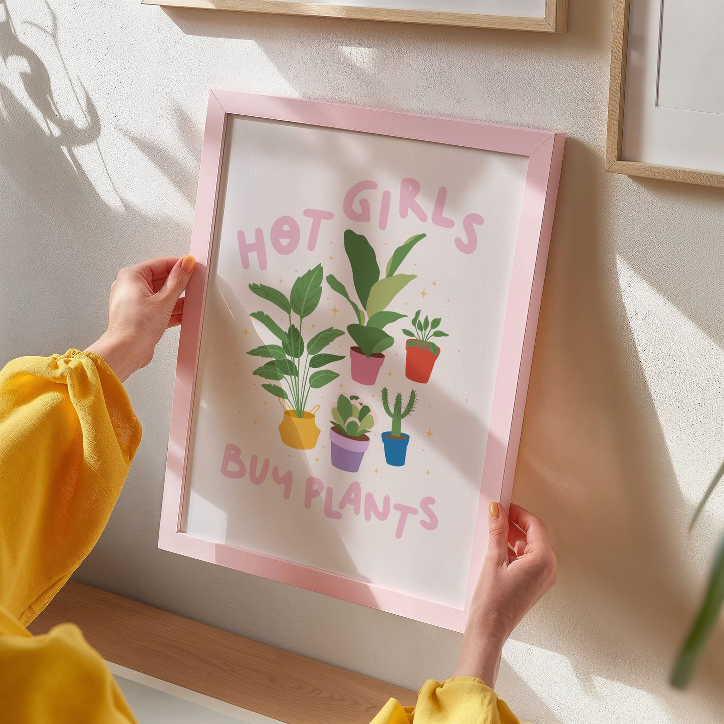 Four illustrations of potted house plants, surrounded by the words hot girls buy plants in pink text.