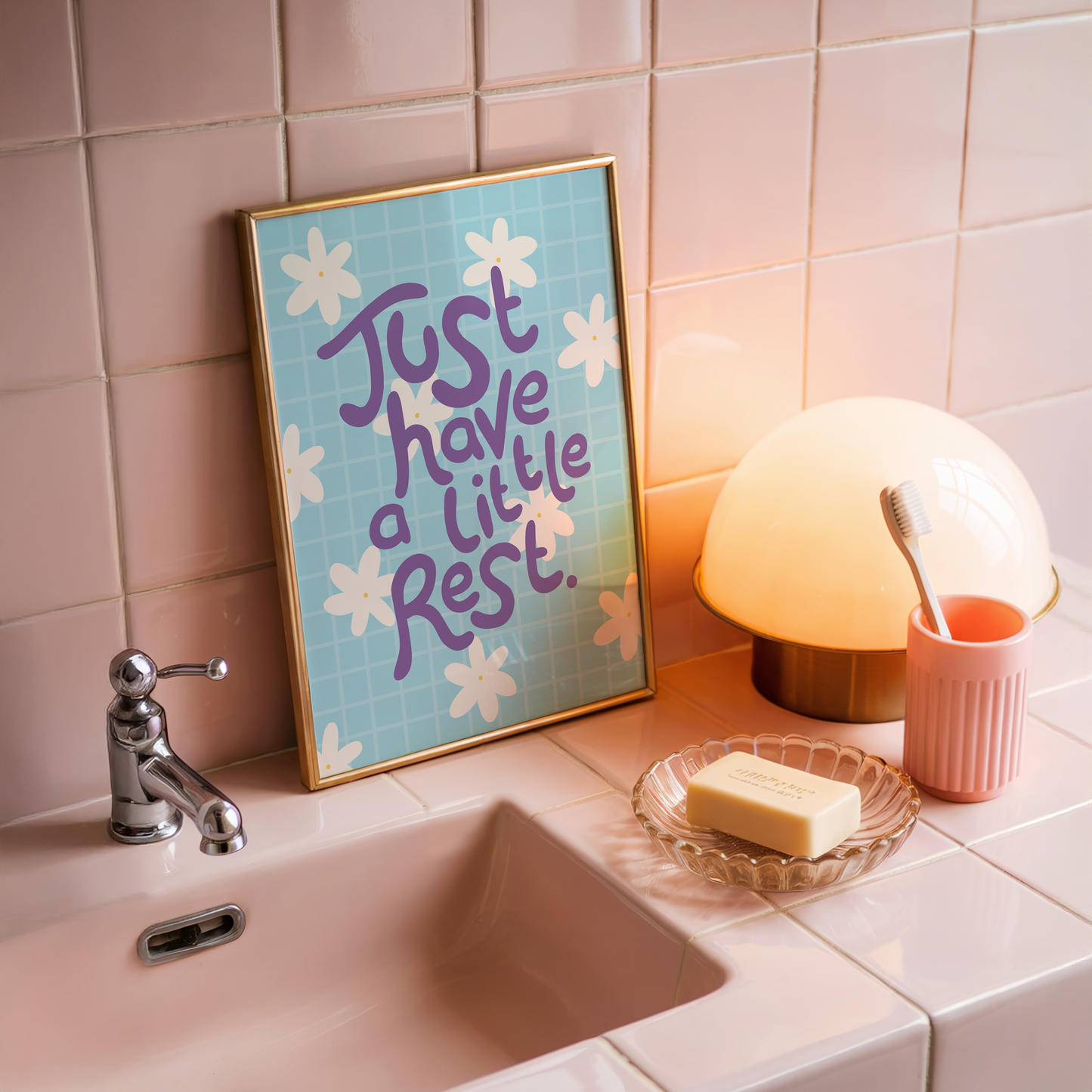 A blue print with a positive quote about resting, decorated with white hand drawn flowers.