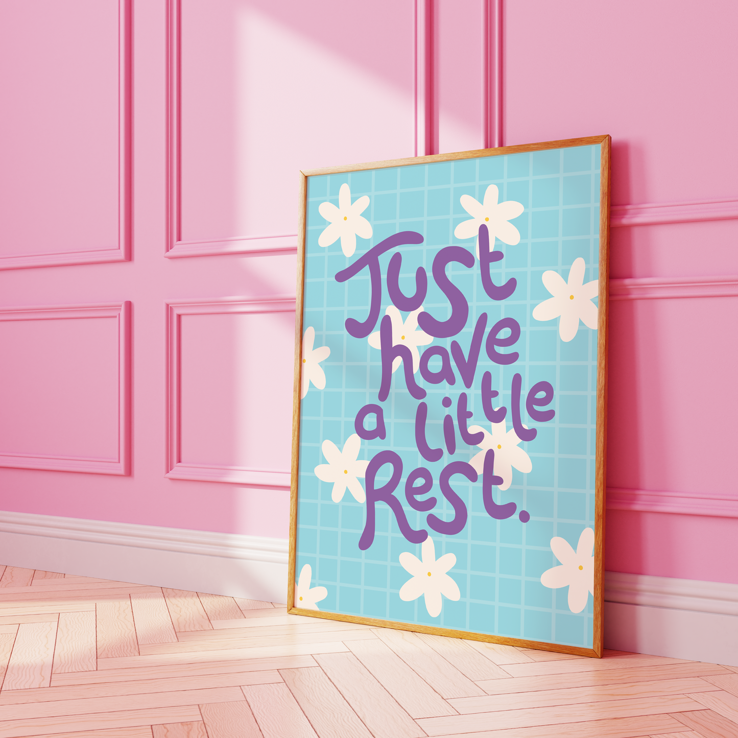 A blue print with a positive quote about resting, decorated with white hand drawn flowers.