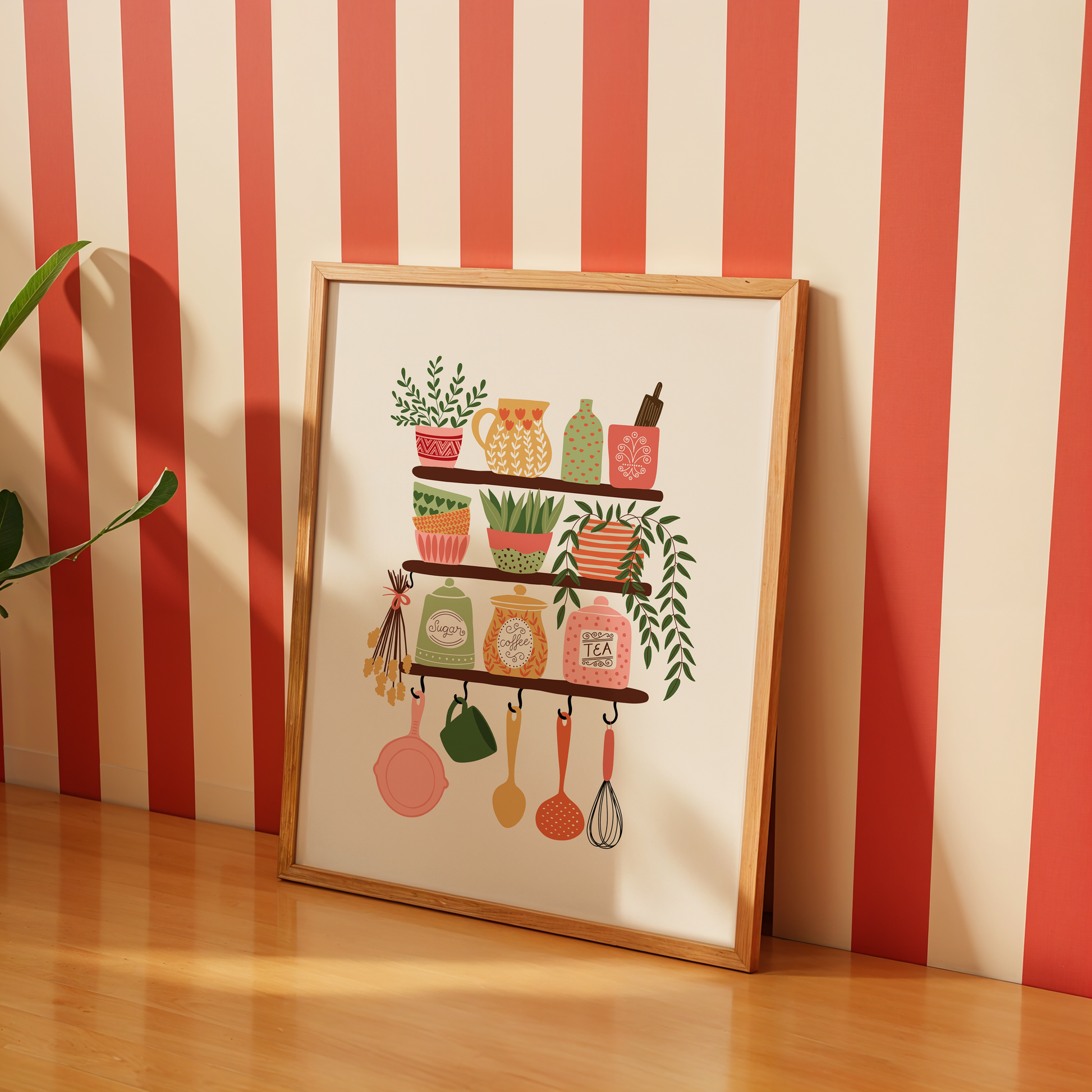 Kitchen scene with a framed print of kitchen items on a white tiled wall.