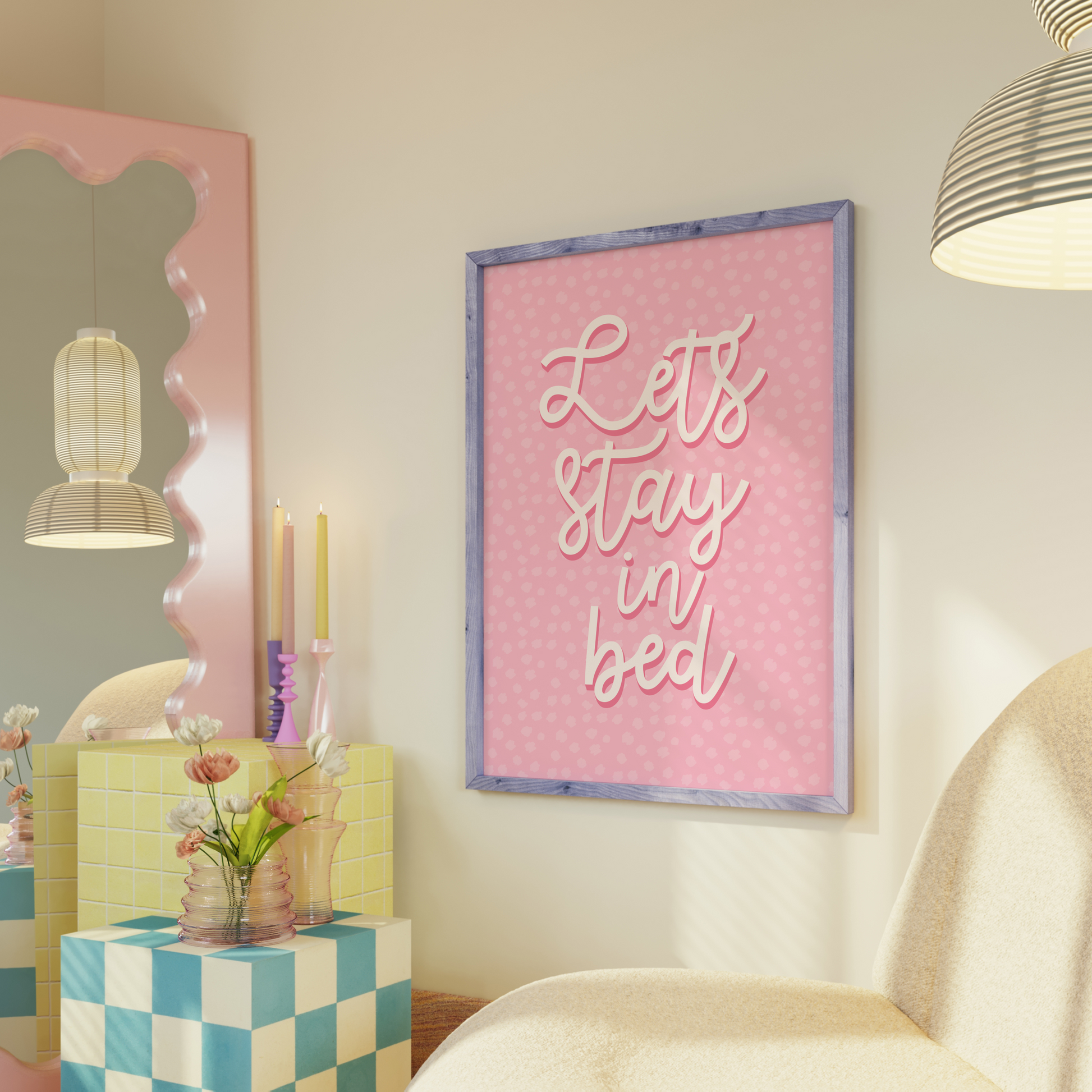 A pink polka dot print, with the words 'lets stay in bed' in a script font in the centre.