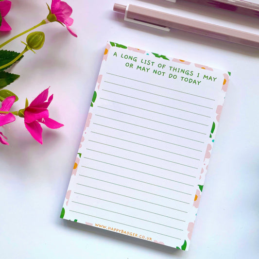 An image of a lined notepad, with a funny quote at the top and a colourful floral border.