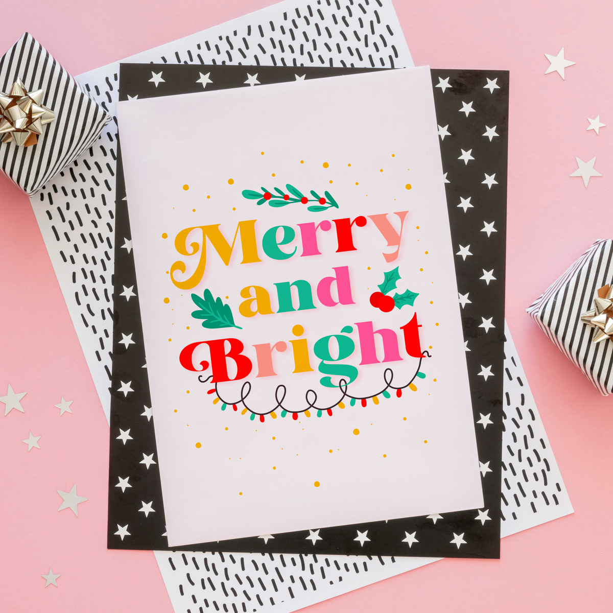 A festive quote print featuring the words 'merry and bright' in lots of bright seasonal colours, surrounded by little festive doodles of Christmas lights and holly.