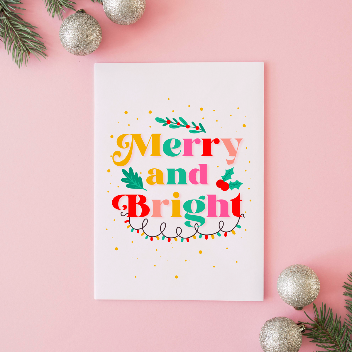 A festive quote print featuring the words 'merry and bright' in lots of bright seasonal colours, surrounded by little festive doodles of Christmas lights and holly.