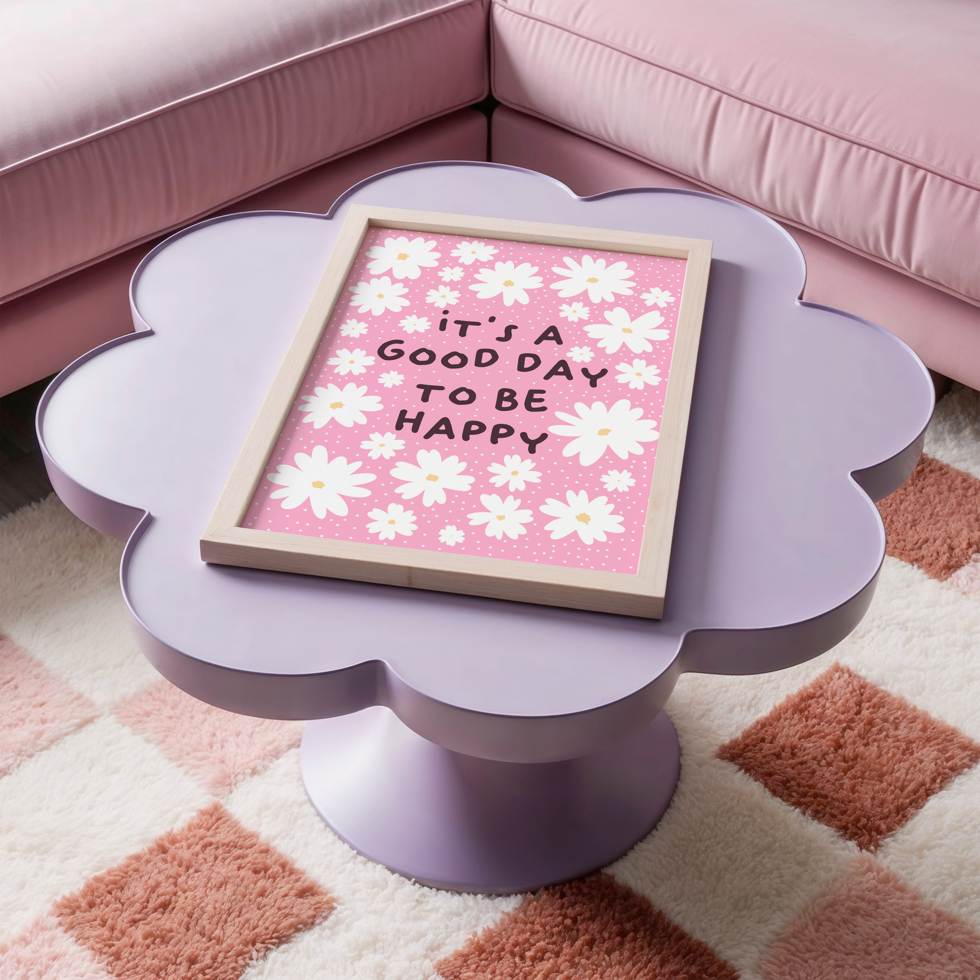 A pink print with several white daisies, surrounding a positivity message of 'it's a good day to be happy'.